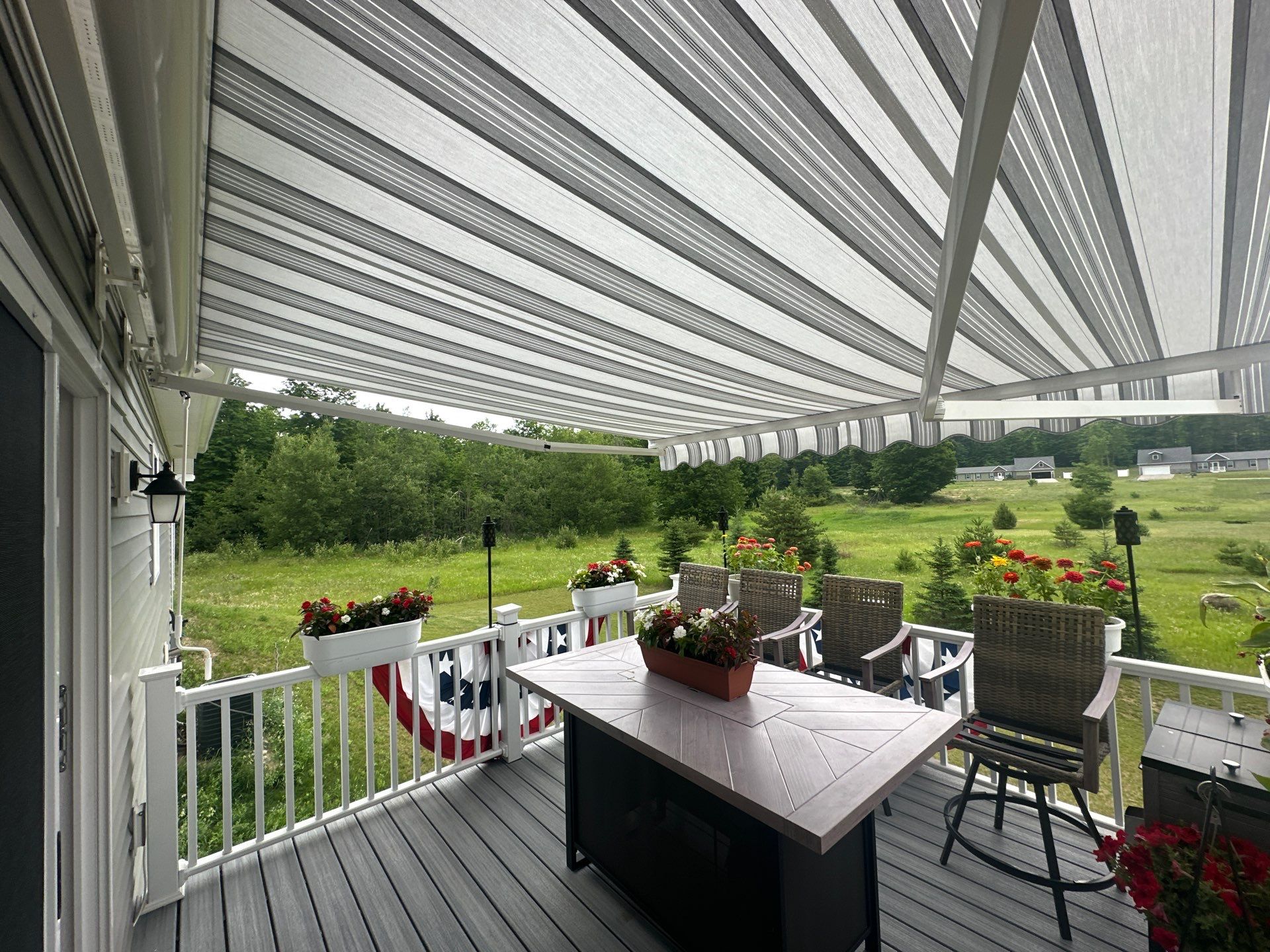Sunesta Retractable Awning Installation Over Petoskey Home Deck by Rainbow Seamless Systems