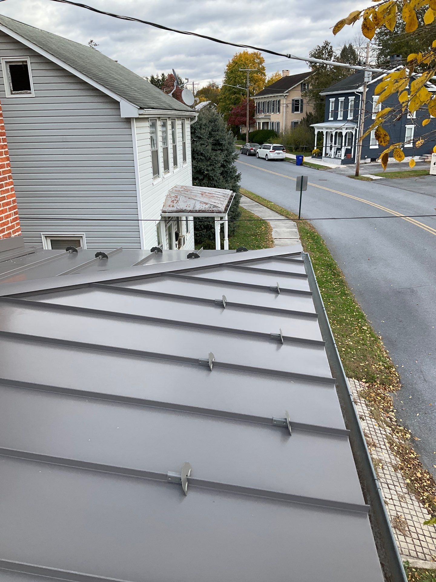 Updated Porch Roof with Clean Standing Seam Lines by Esh Builders