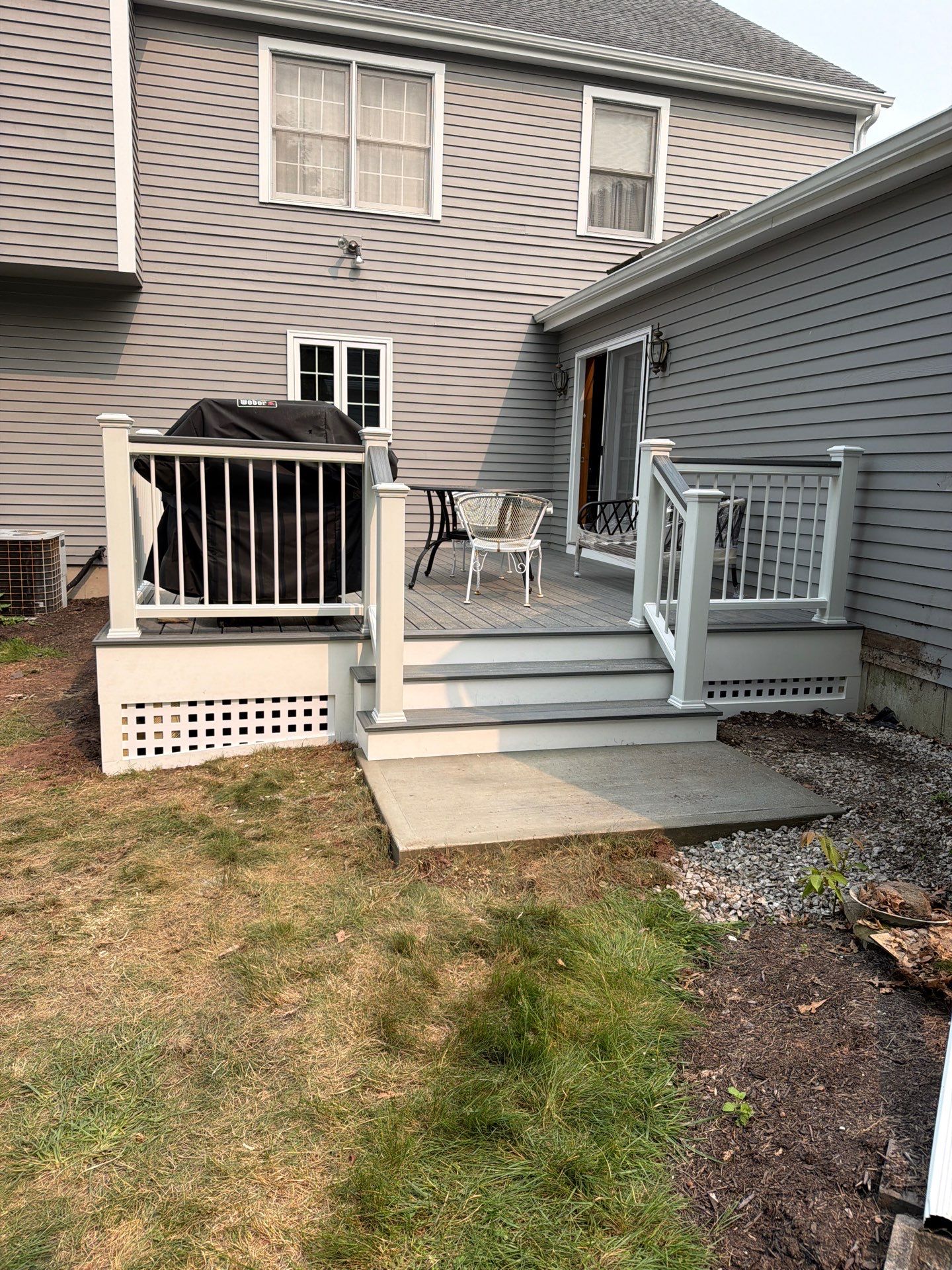 Replacement deck using Trex Tropical Island mist decking and matching cocktail railing. Enclosed with Lattice by DiGiorgi Roofing and Siding Inc