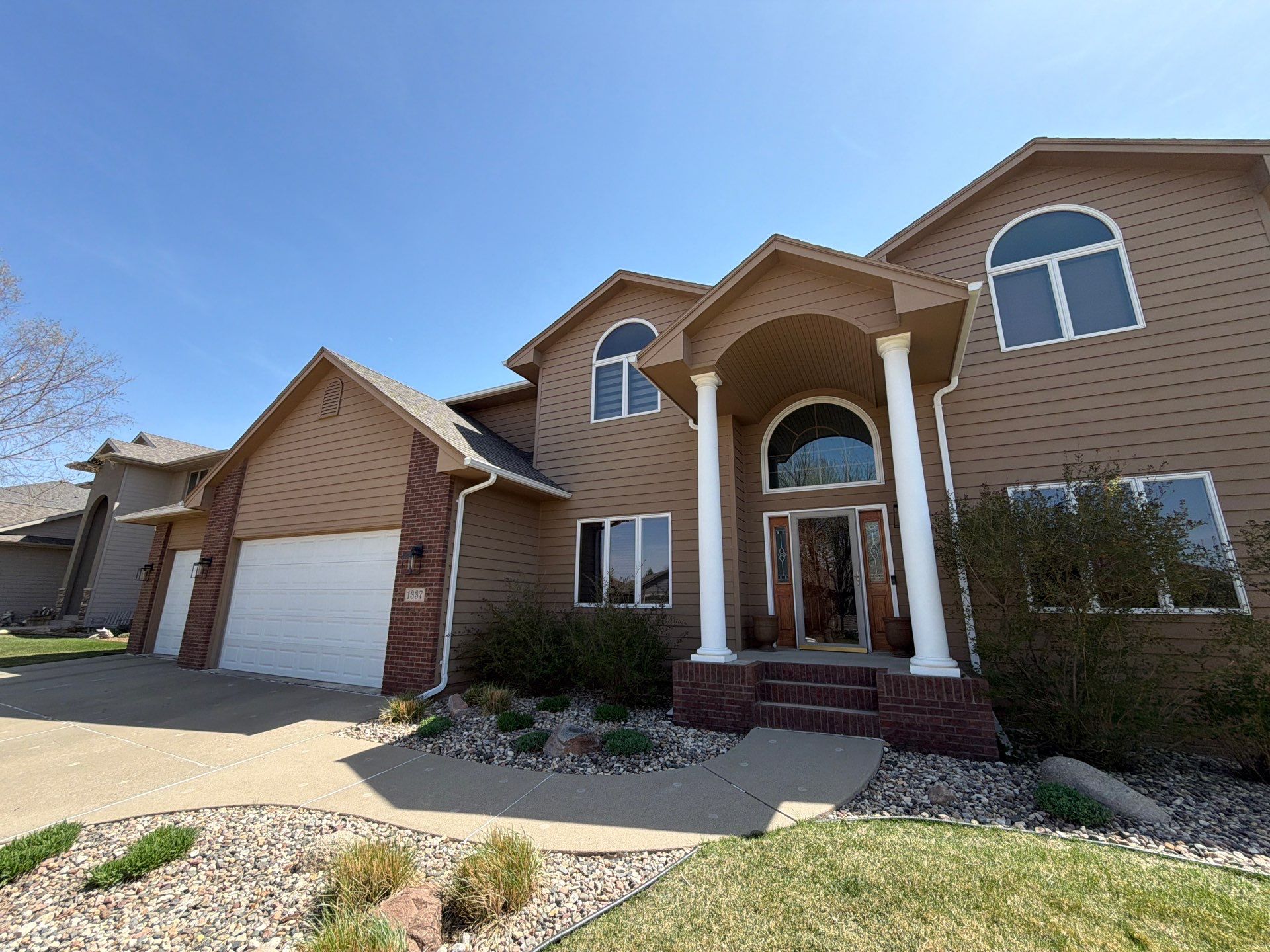Full Exterior House Painting and Deck Staining in Sioux Falls by Select Painting, Coatings & Garage Cabinets