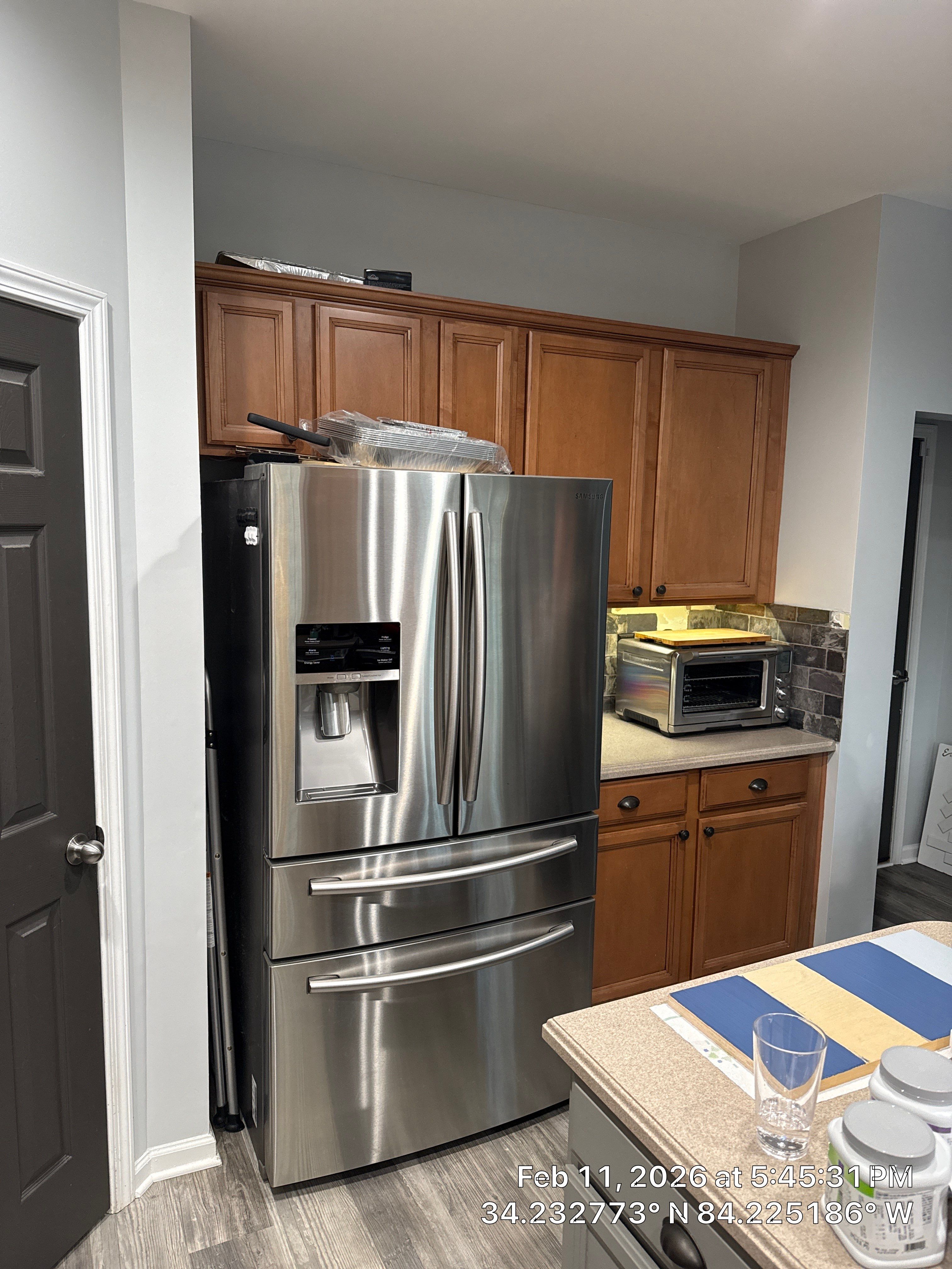 Modern Kitchen Remodel With Grey Shaker Cabinets and Navy Blue Island by Heart & Home Kitchen & Bath Remodeling LLC