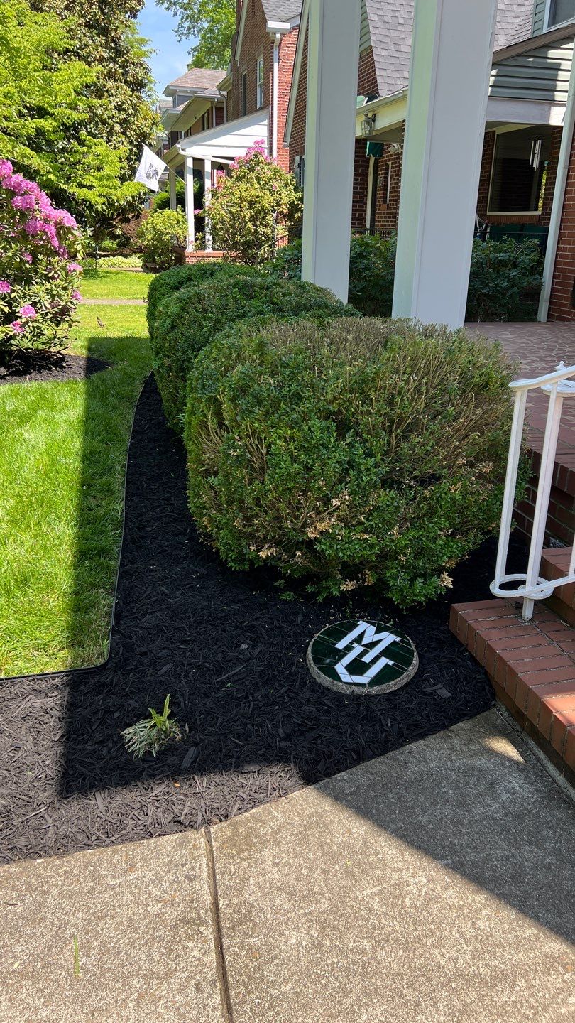Liriope grasses, mulch and stone pavers by GrassBusters, Inc.