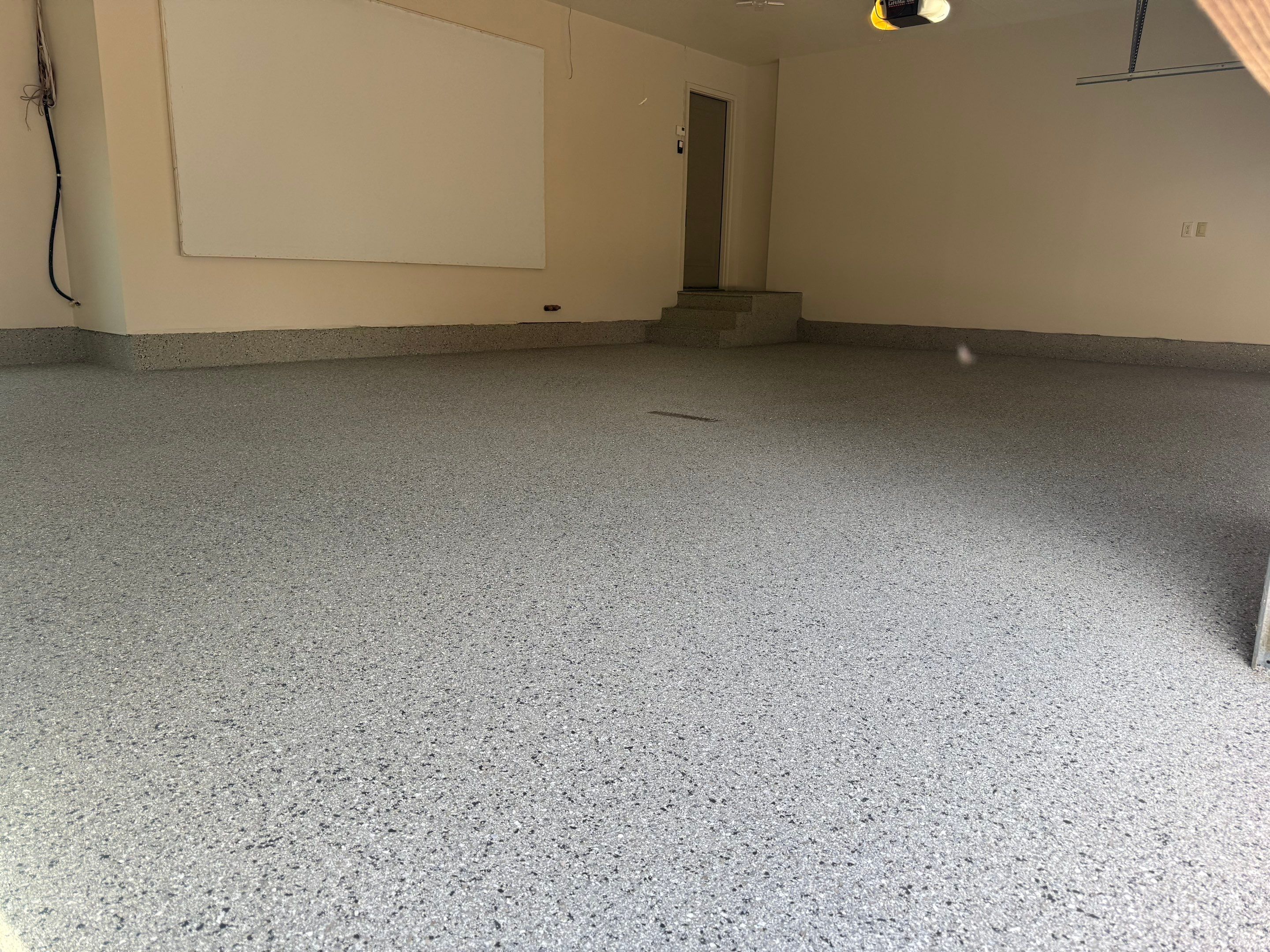 Residential Garage Floor Coating with Grey Speckled Epoxy Finish by Select Painting, Coatings & Garage Cabinets