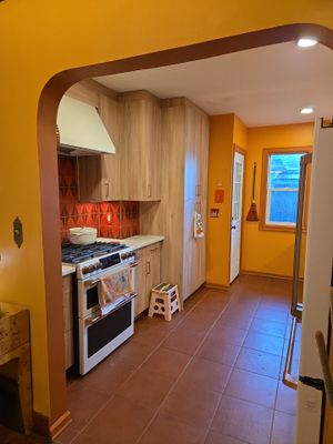 Complete Kitchen Remodeling Featuring Terracotta Tile and Wood Cabinetry