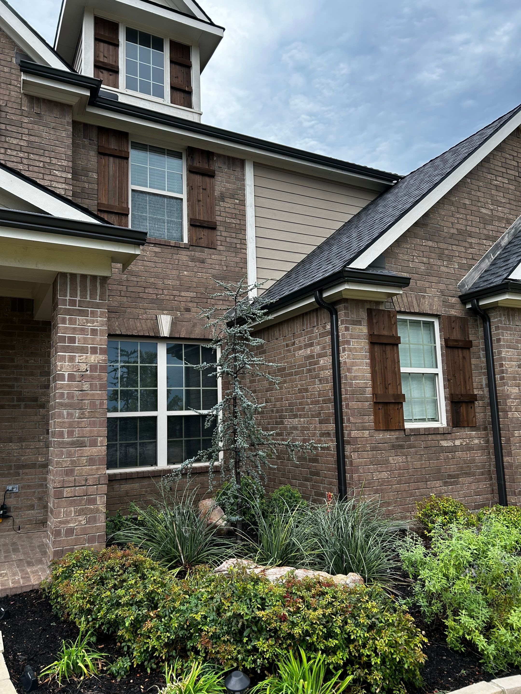 Medium brown brick with GAF Pewter Gray  by Tejas Roofworks + Restoration