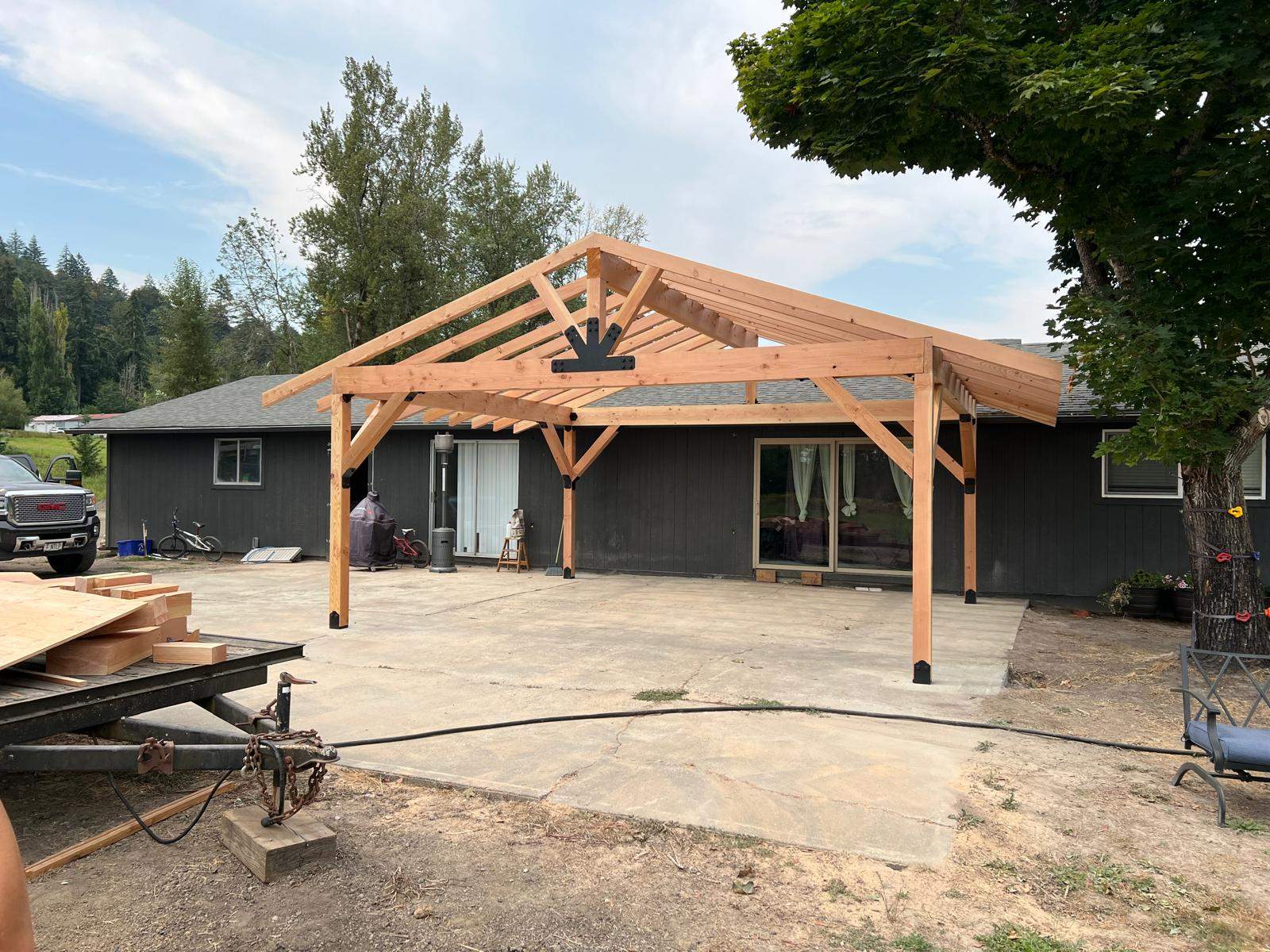 Custom Timber Frame Patio Cover with Black Metal Roof by American Made Construction