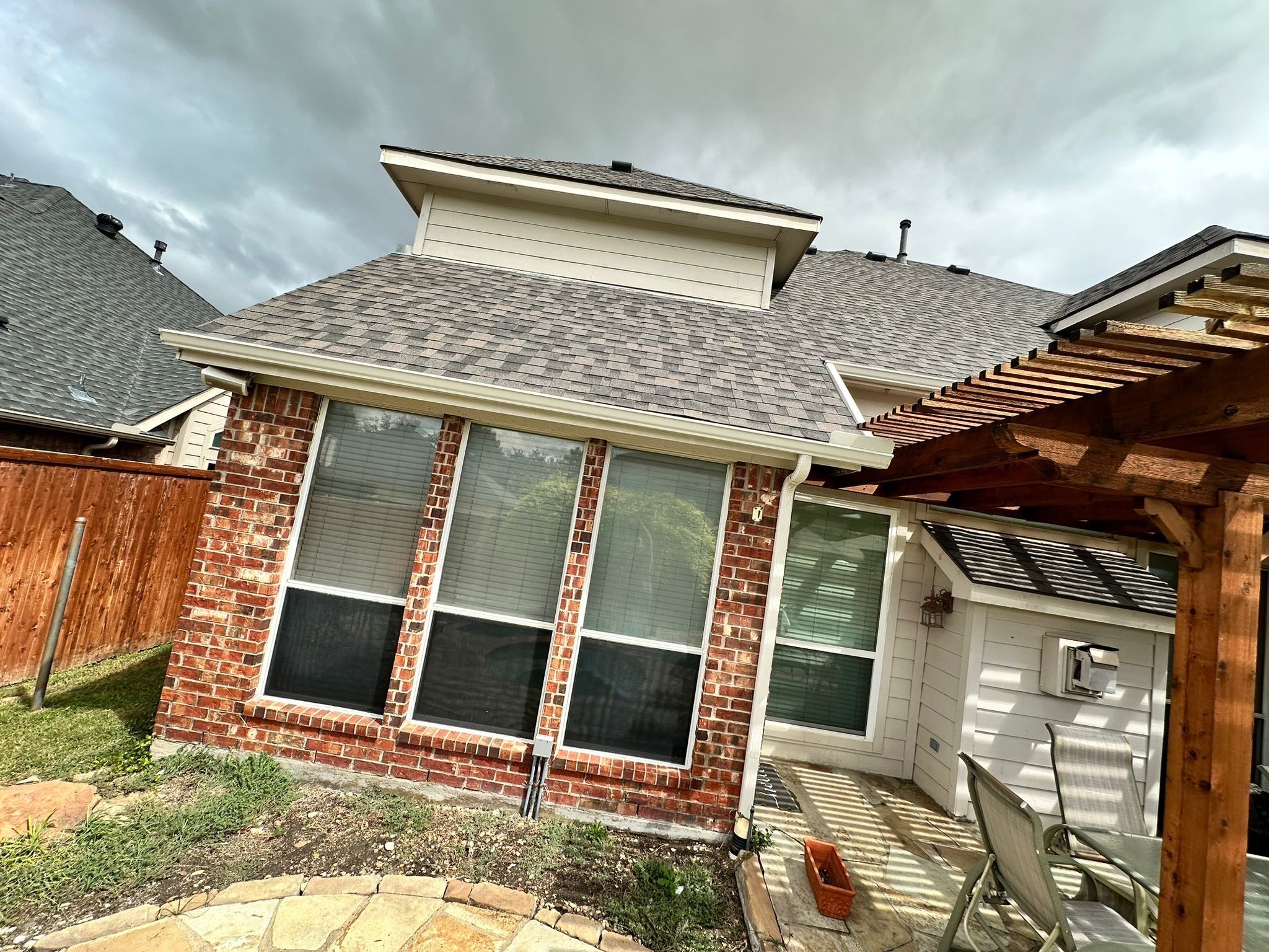 IKO Cornerstone-Dark Reddish Brown brick house  by Tejas Roofworks + Restoration
