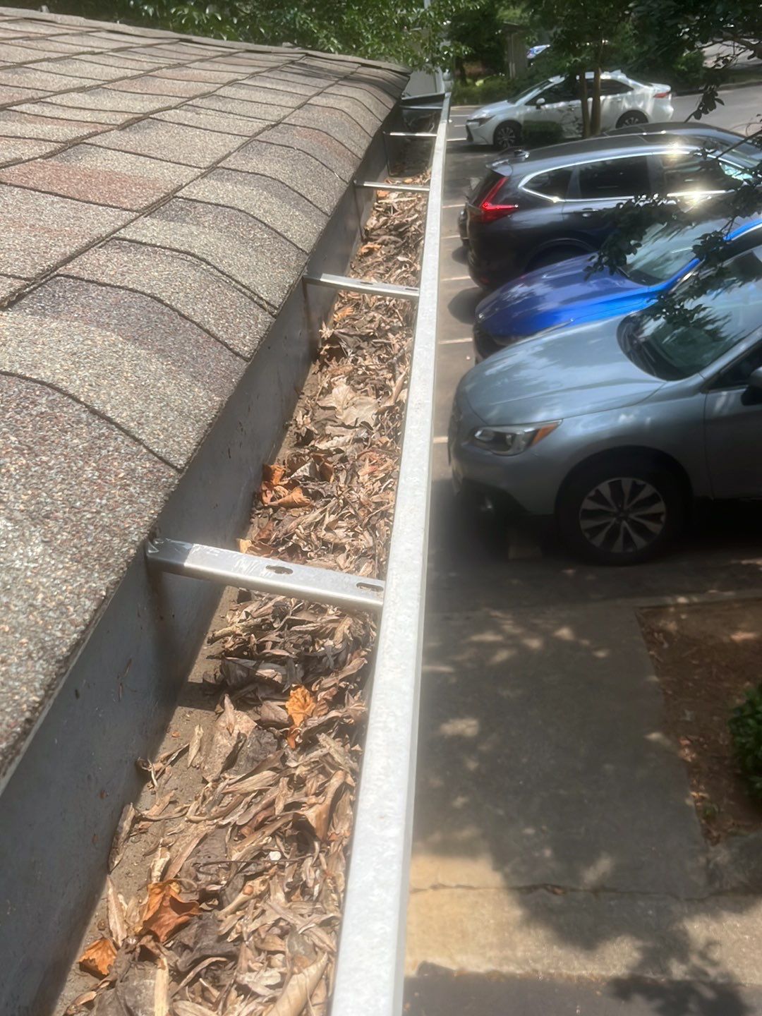 Commercial gutter cleaning Holly Springs & Fuquay-Varina, NC before photo with filled gutters