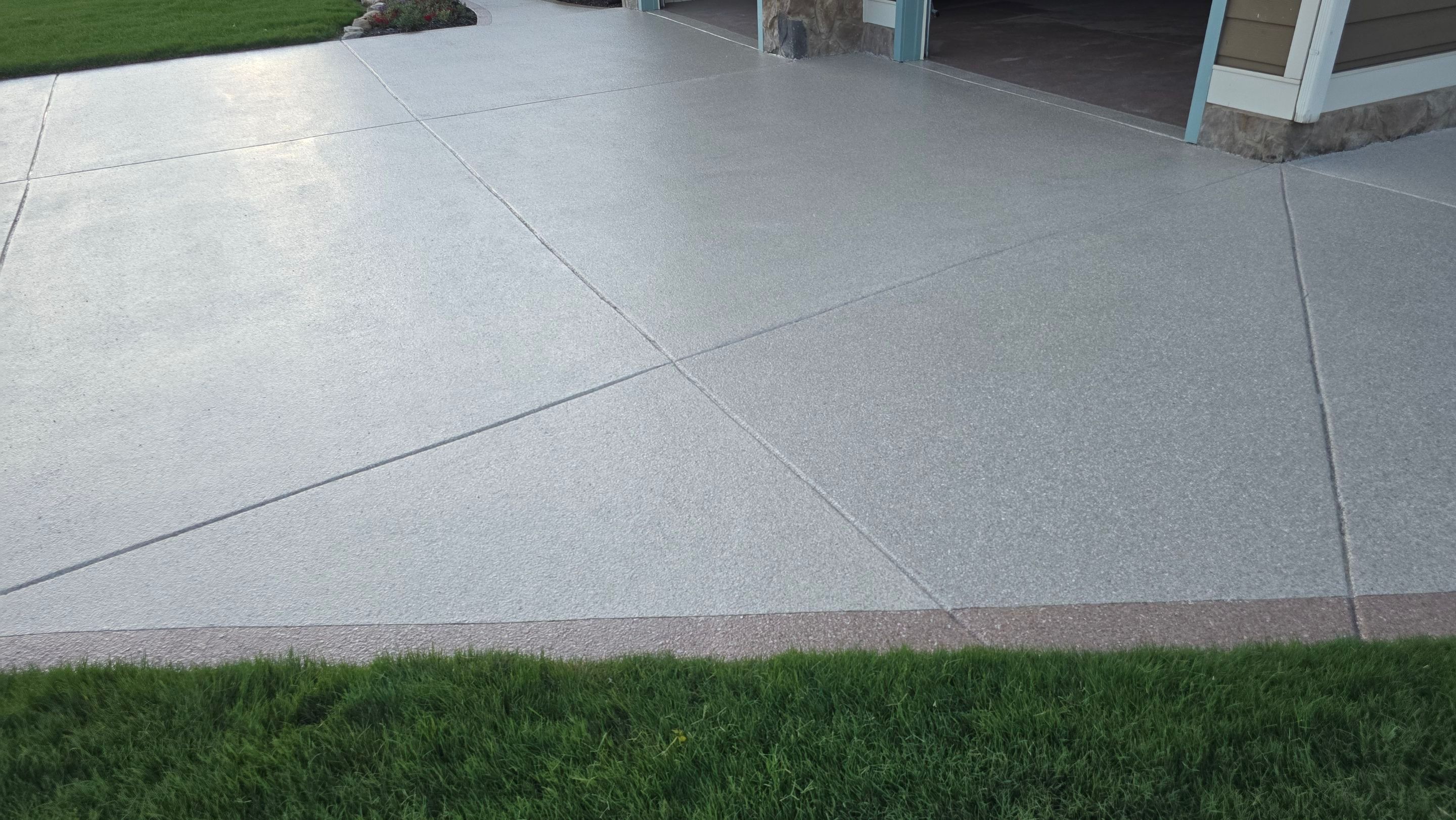 Driveway and sidewalk using Feldspar with the border done in Spilite by Elite Floor Solutions