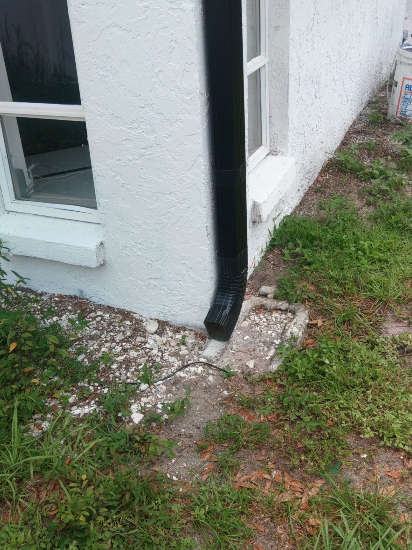 Black seamless gutters and downspouts installation in Sarasota, FL by Gutter Professors