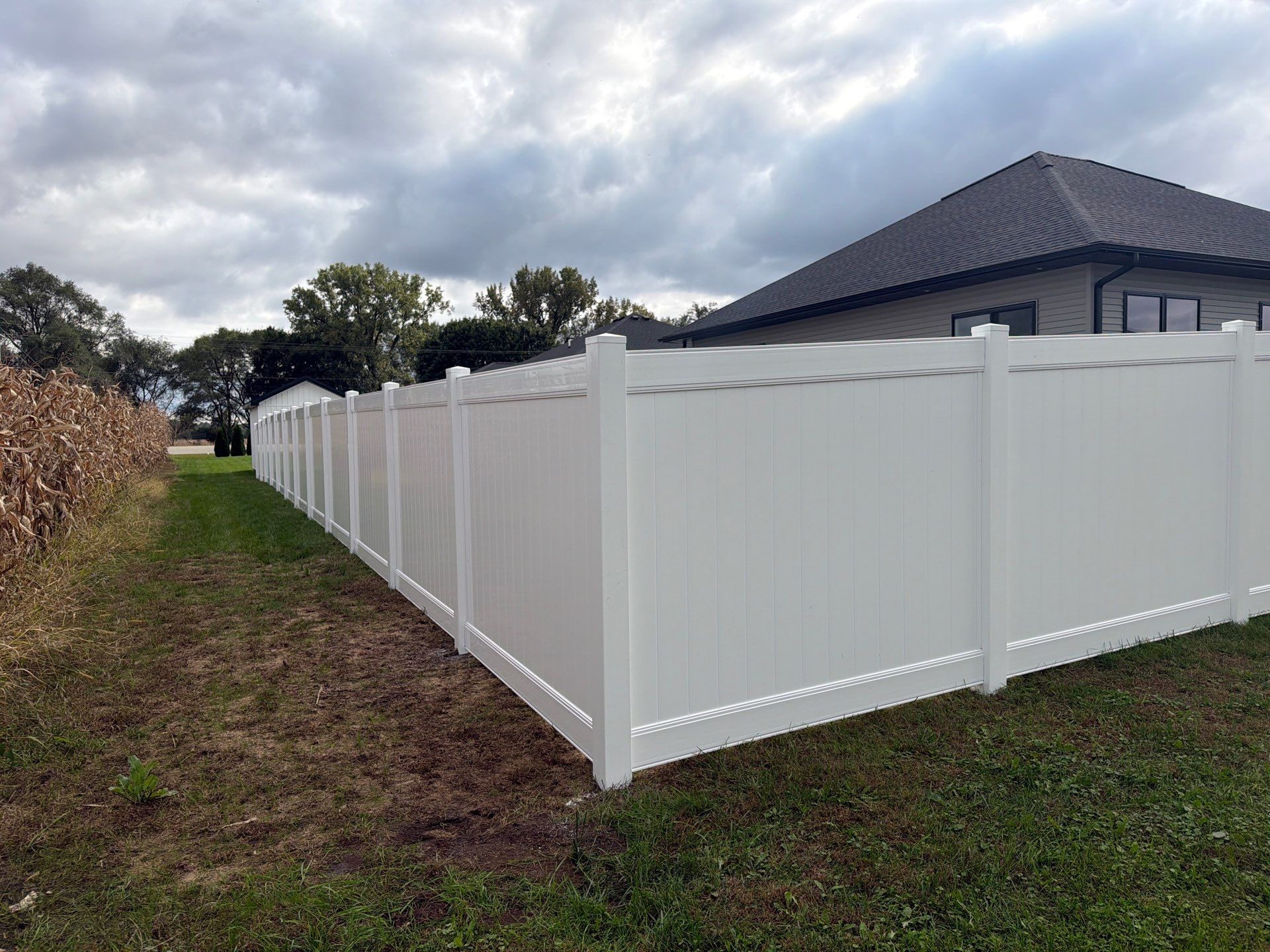 Residential White Vinyl Privacy Fence Installation in Janesville by Perfect Picket Fence and Stain