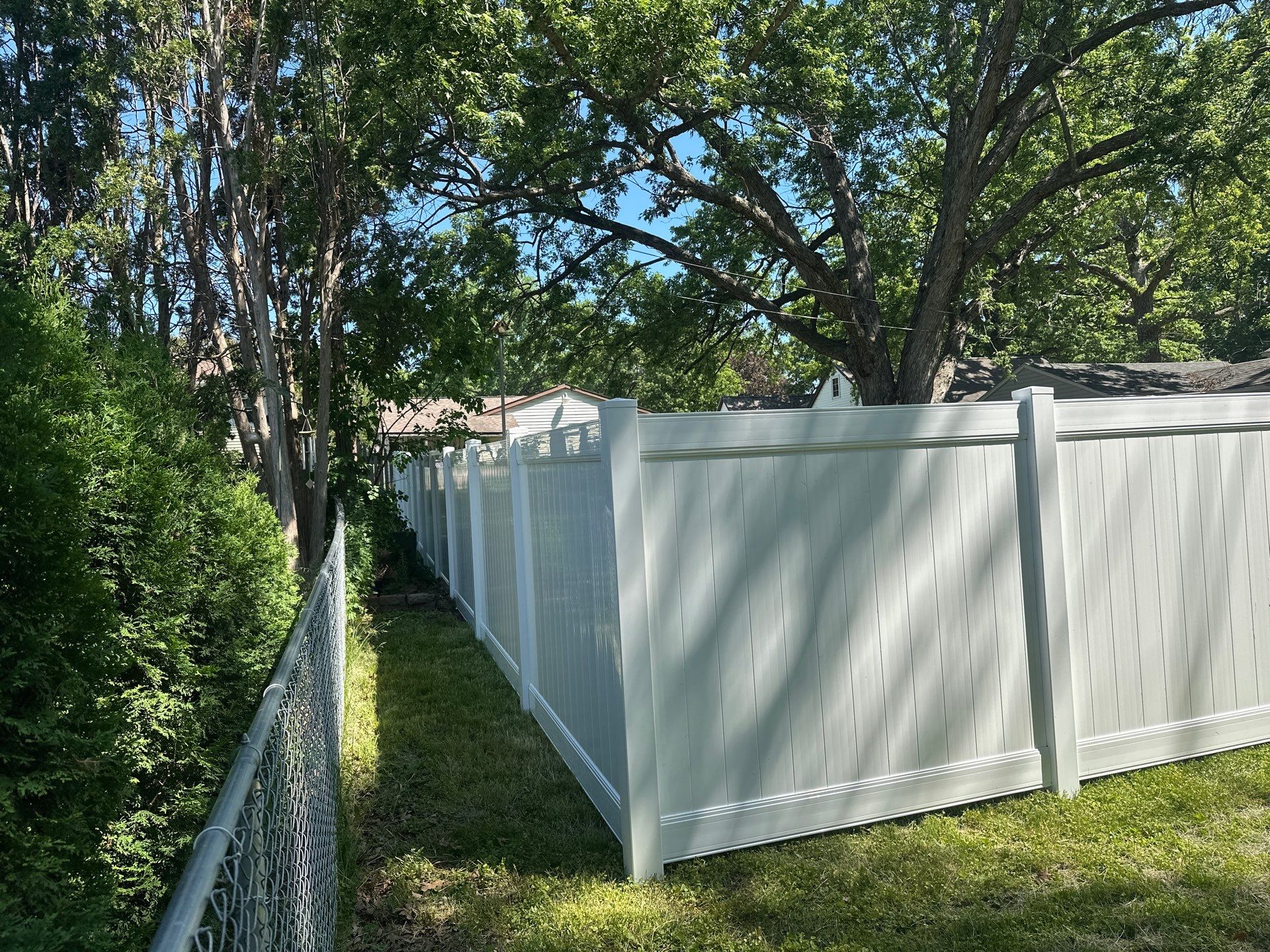 White Vinyl Privacy Fence and Double Gate Installation in Cedar Falls by Perfect Picket Fence and Stain