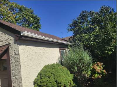 White Seamless Gutter Installation for West Hempstead Stucco Home