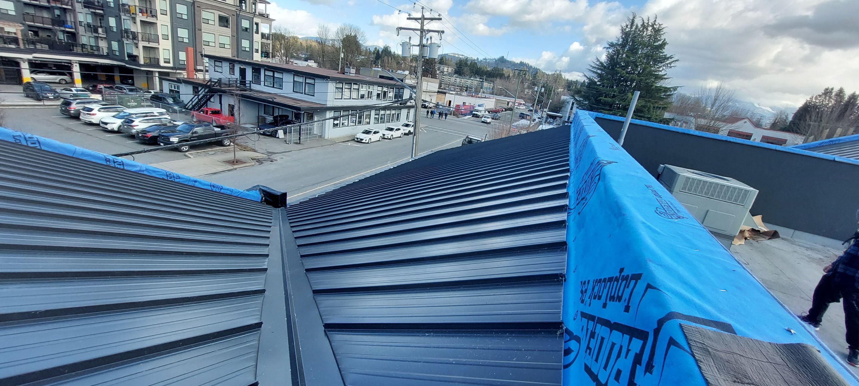 Commercial Roofing Installation using 12" Prolok metal and hidden gutters! by Top Notch Roofing Inc