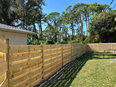 Wood Fence Installation using 6 Ft. Tall Pressure Treated Wood Shadowbox Fence