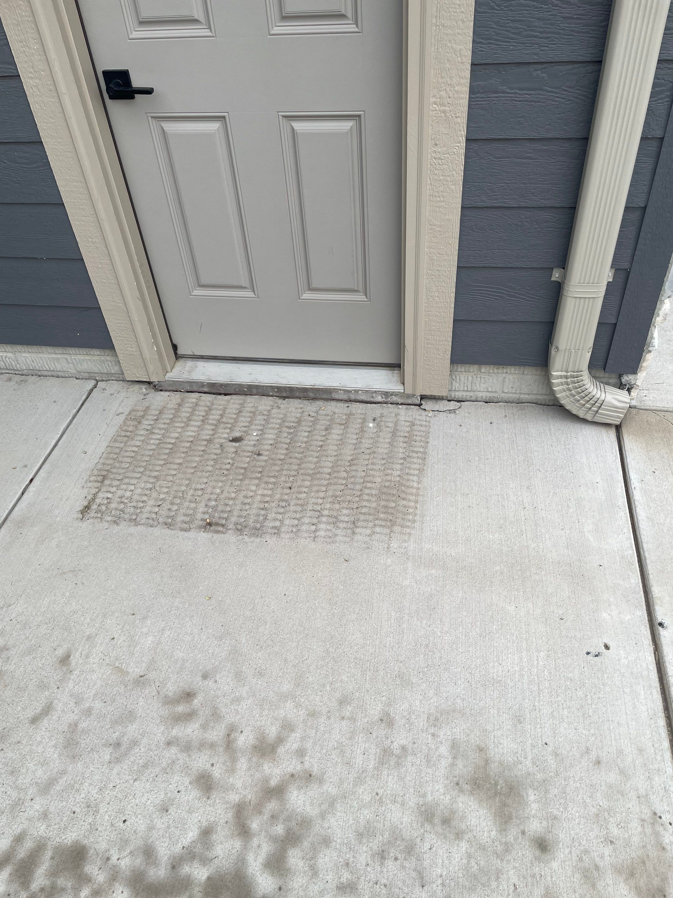 Textured Concrete Patio Coating and Custom Privacy Pergola in Sioux Falls by Select Painting, Coatings & Garage Cabinets