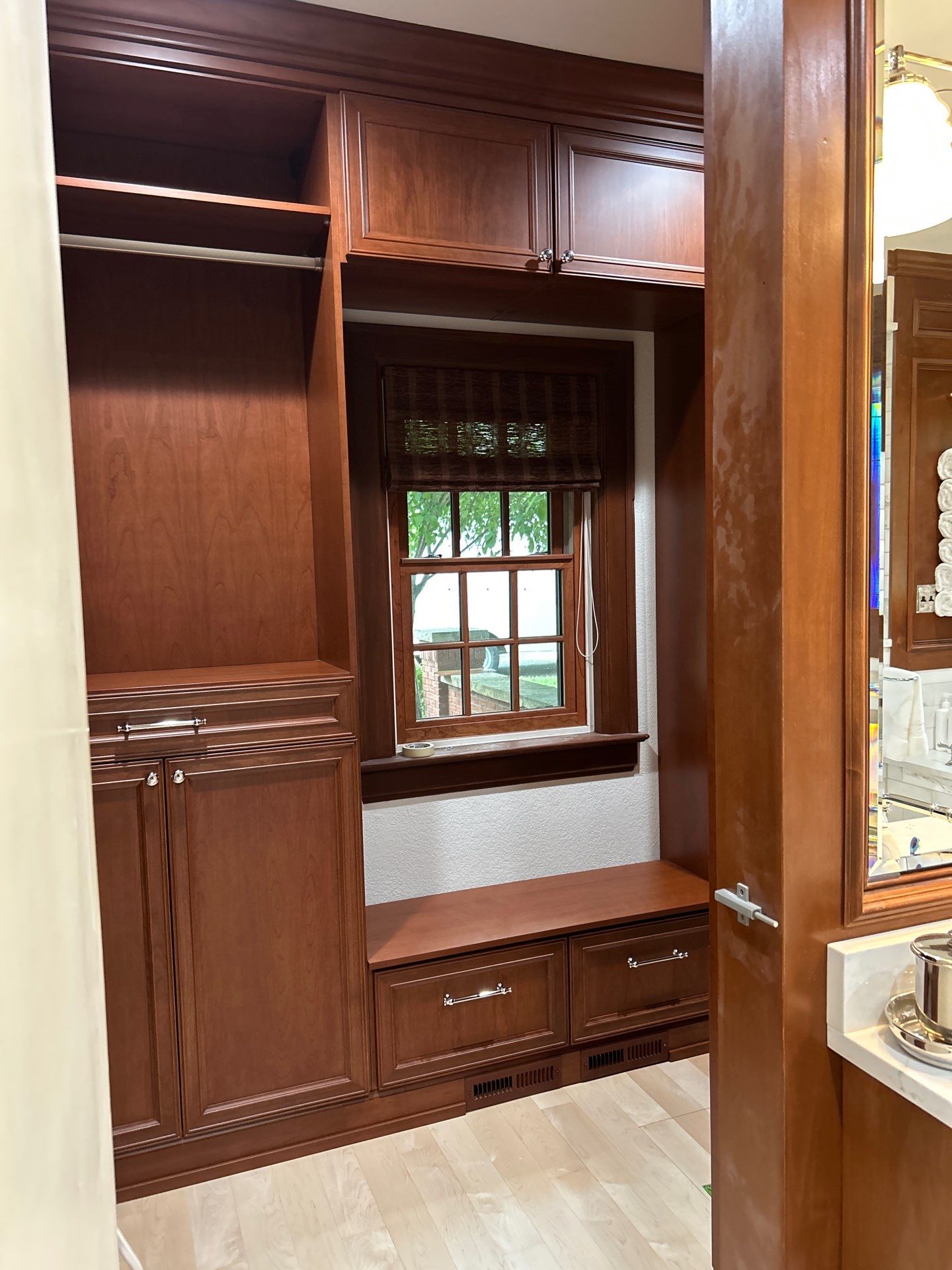 Stained Cherry Wood Primary Closet by Concept 32, Inc.