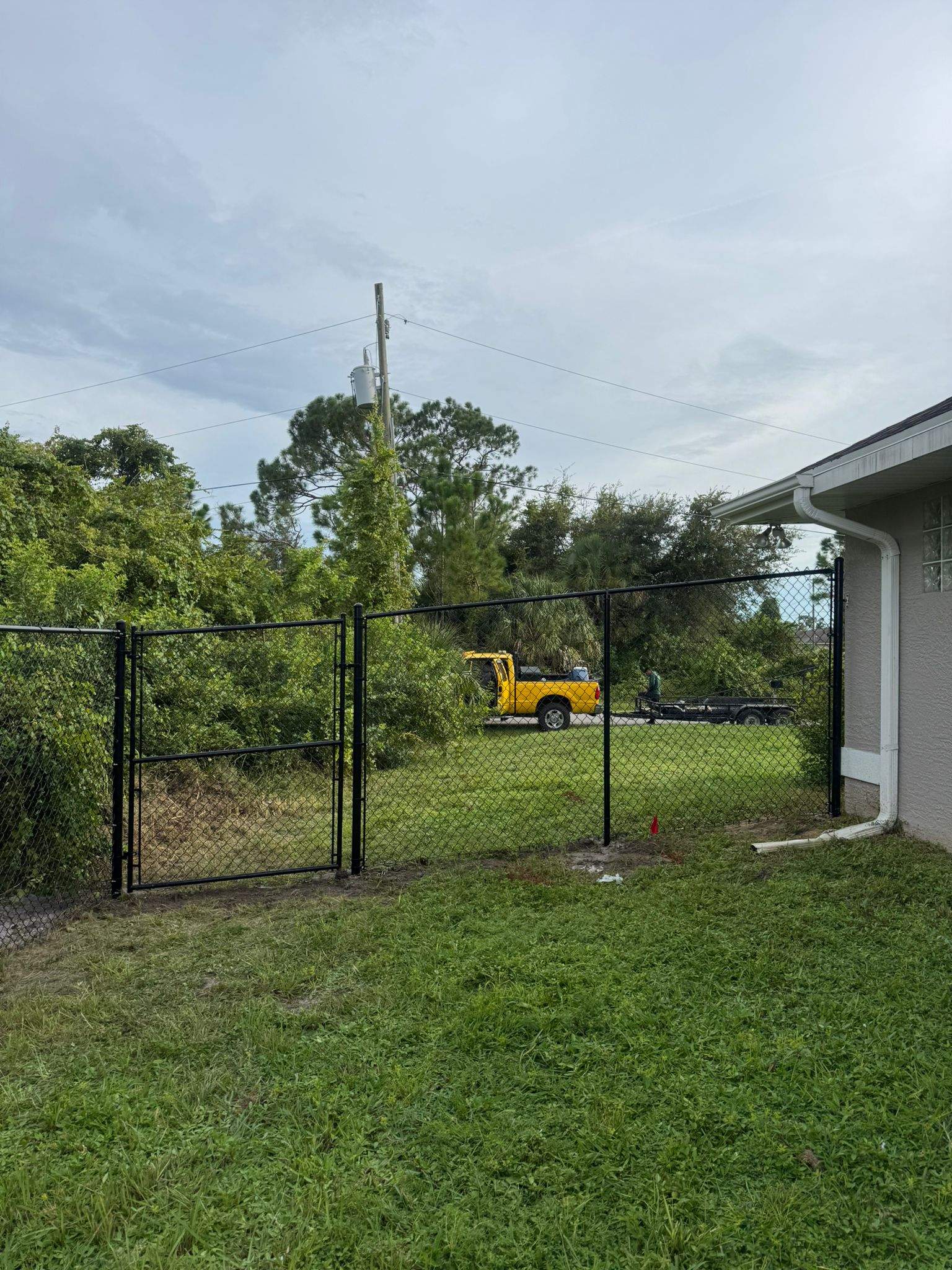 Black Vinyl-Coated Chain Link Fence and Gate Installation in North Port by True Fence LLC