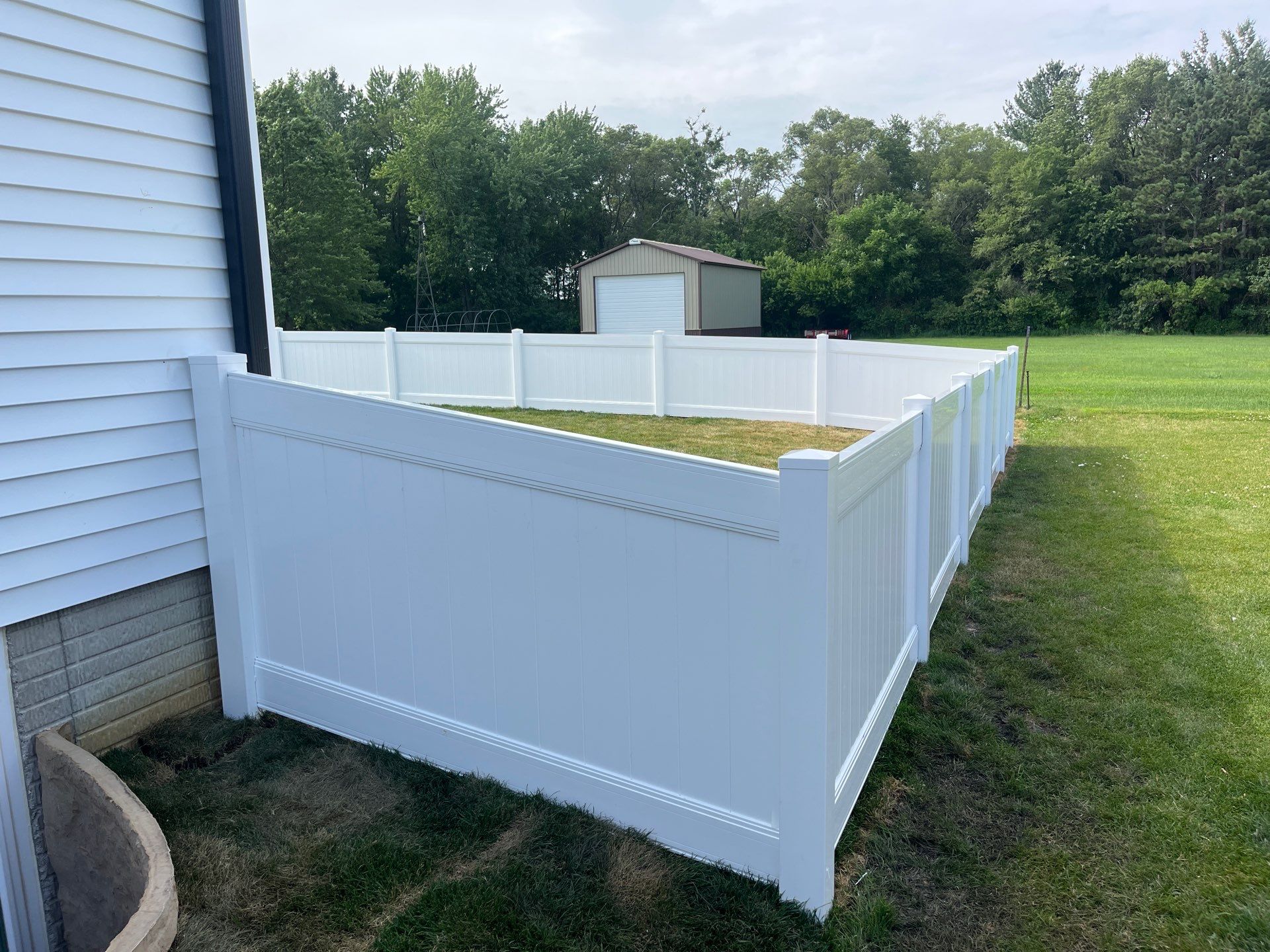 White Vinyl Privacy Fence With Pet Window in Cedar Falls by Perfect Picket Fence and Stain