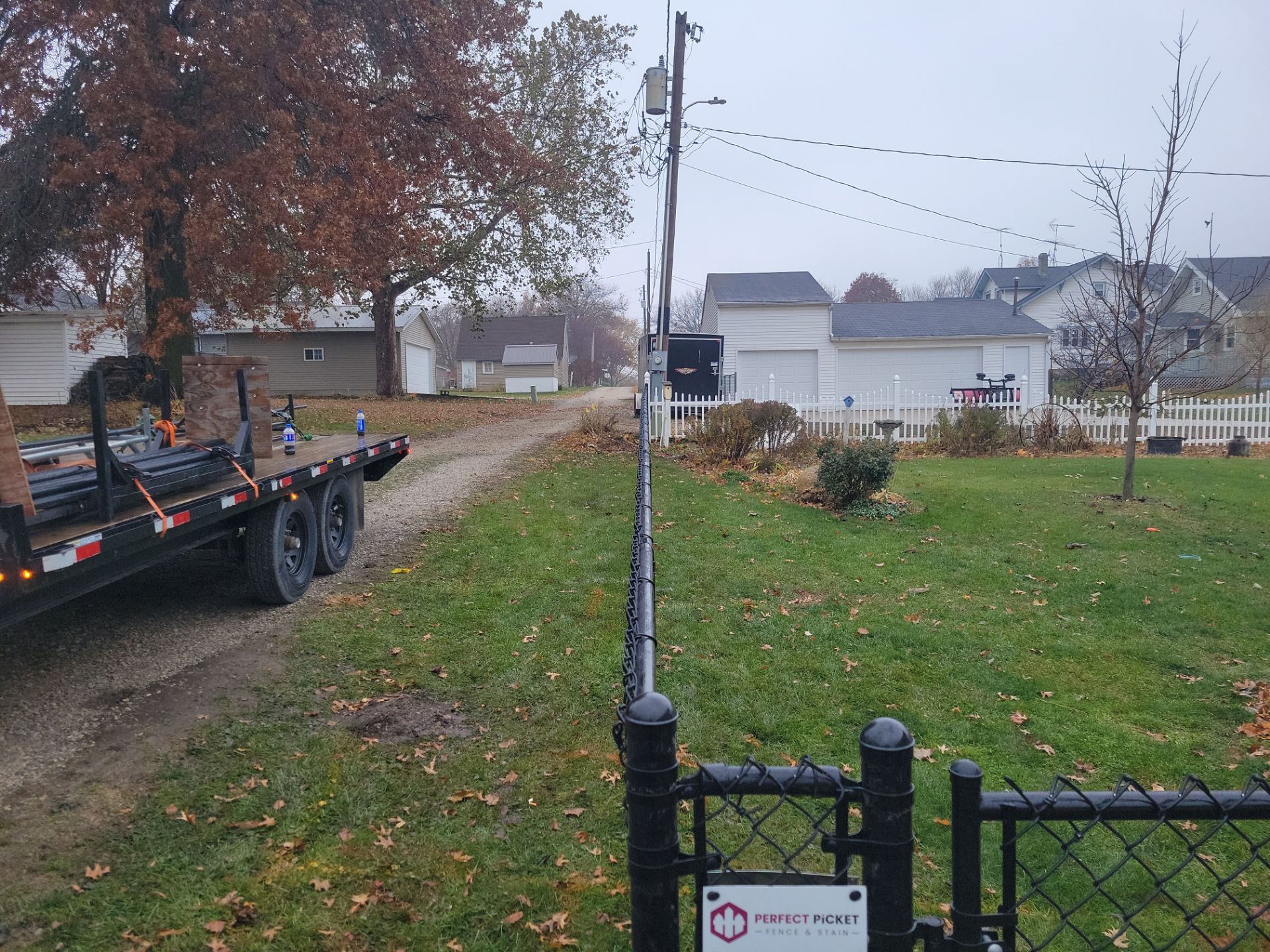 Black Vinyl-Coated Chain Link Fence Installation in Aplington by Perfect Picket Fence and Stain