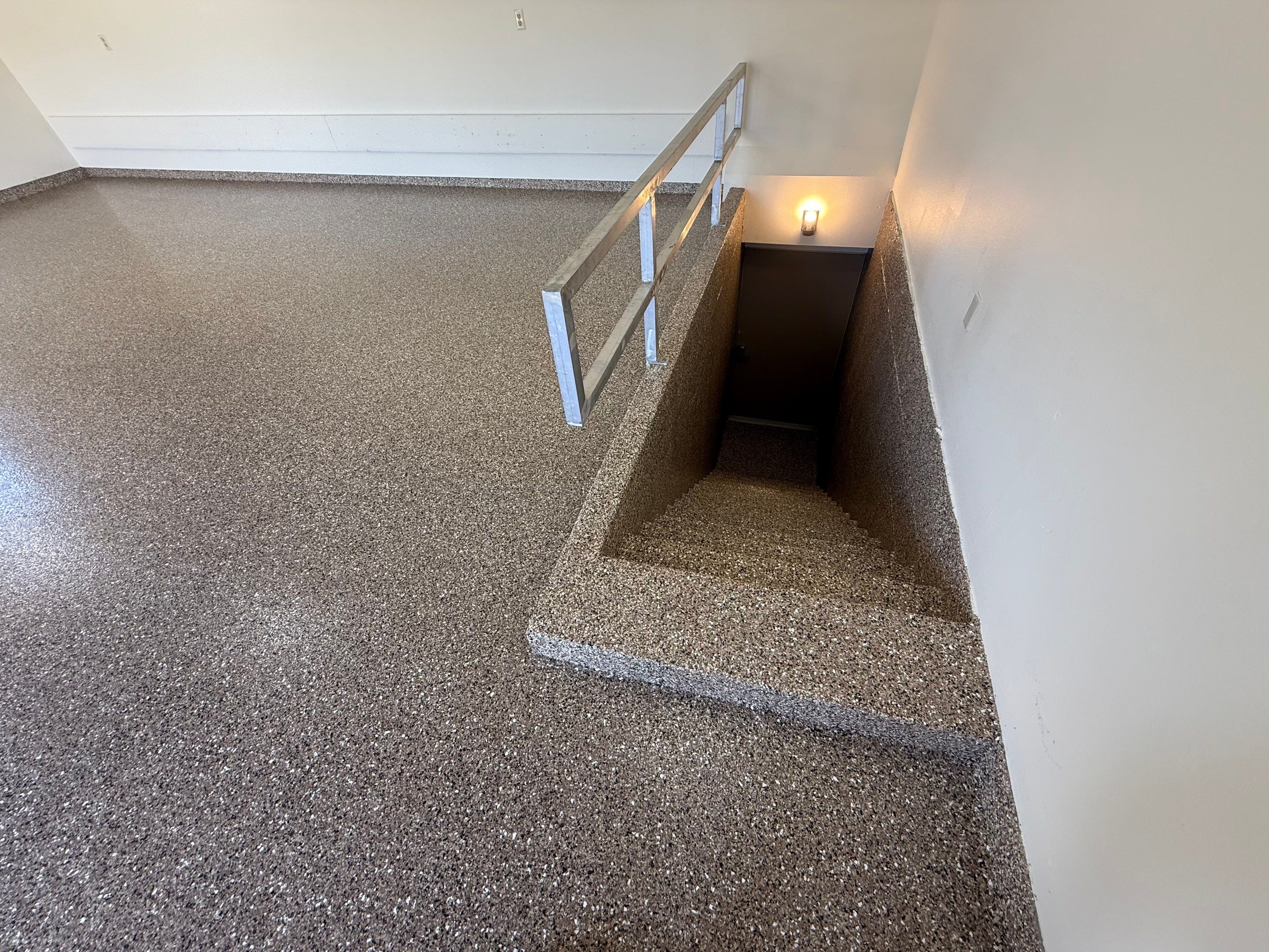 Custom Polyaspartic Garage Floor and Stairwell Coating in Pipestone by Select Painting, Coatings & Garage Cabinets