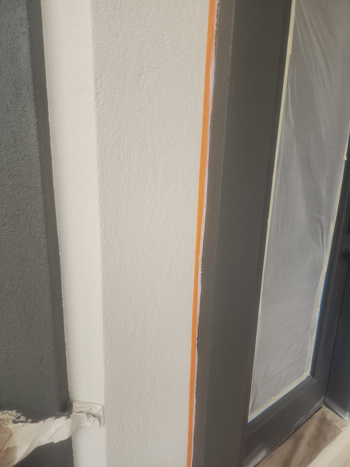 Castle Rock Elegance: White Stucco Exterior with Bold Tricorn Black by J&M Painting LLC