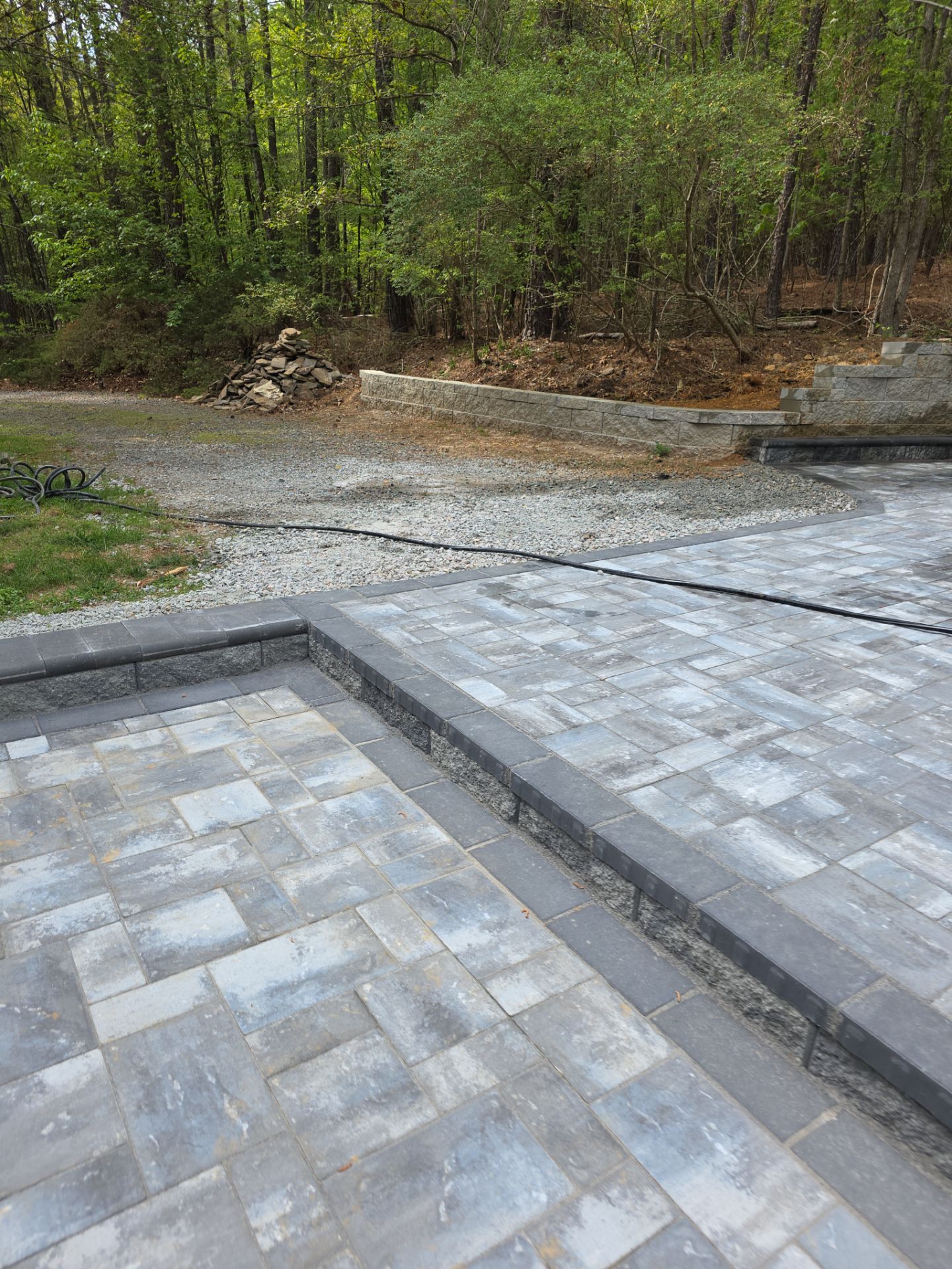 Pittsboro Outdoor Living Transformation – Retaining Wall, Paver Patio & Elevated Deck by Elite Remodeling and Design LLC