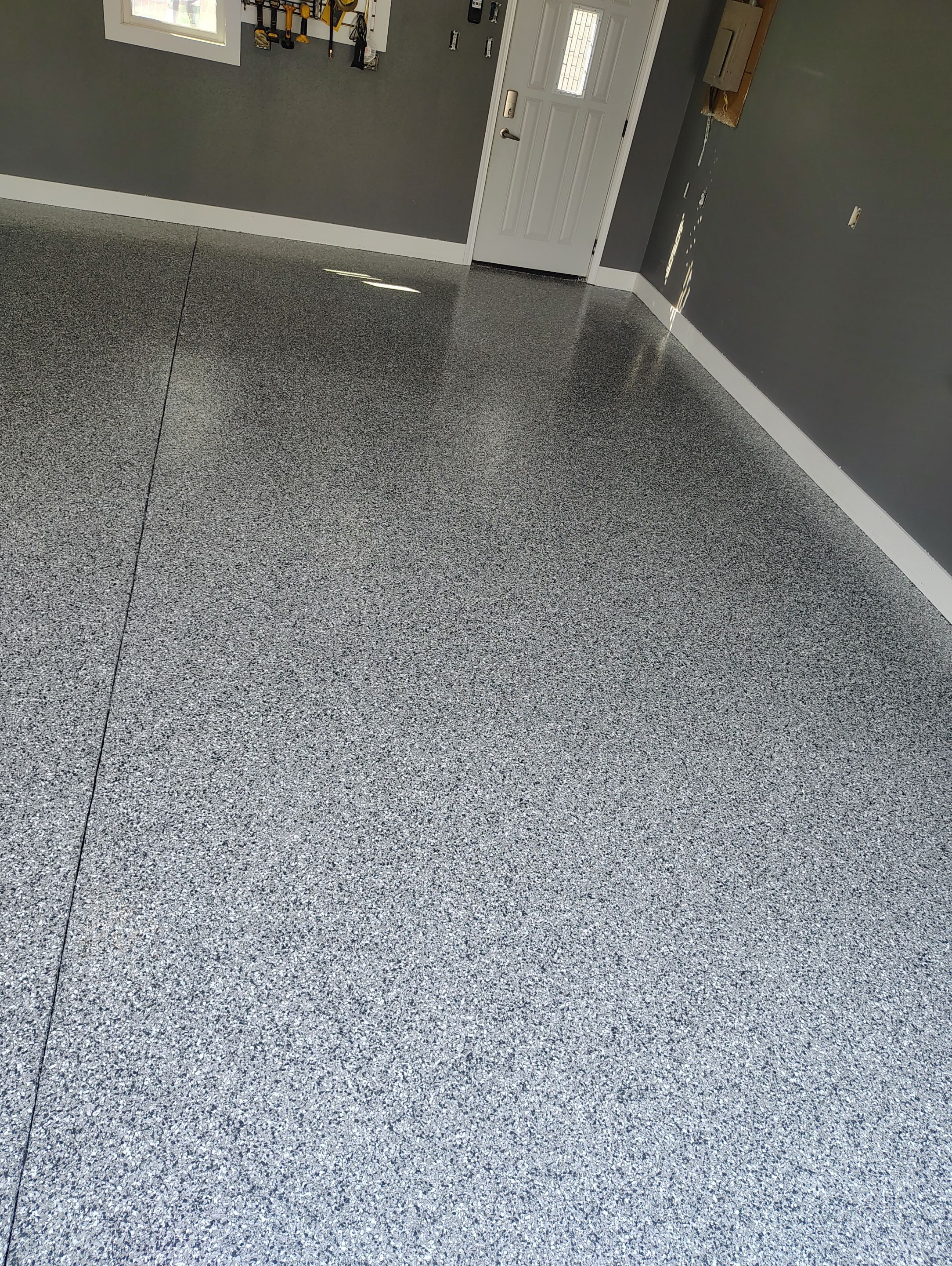 Custom Garage Floor Coating and Backyard Patio Refinishing in Tyndall by Select Painting, Coatings & Garage Cabinets