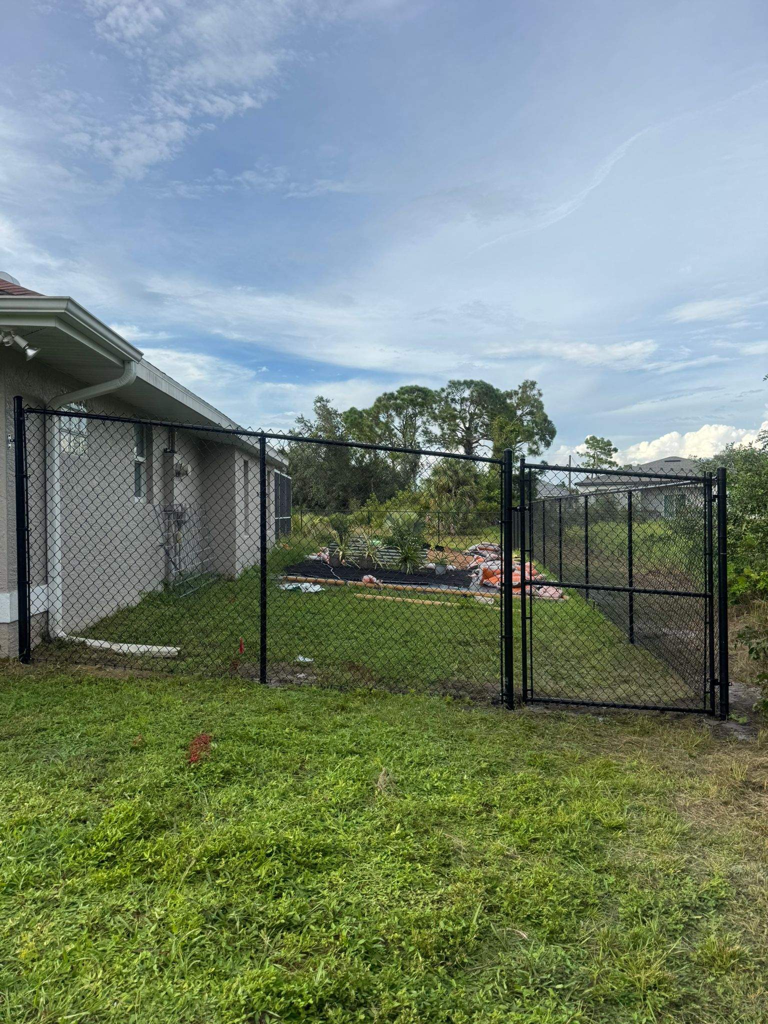 Black Vinyl-Coated Chain Link Fence and Gate Installation in North Port by True Fence LLC