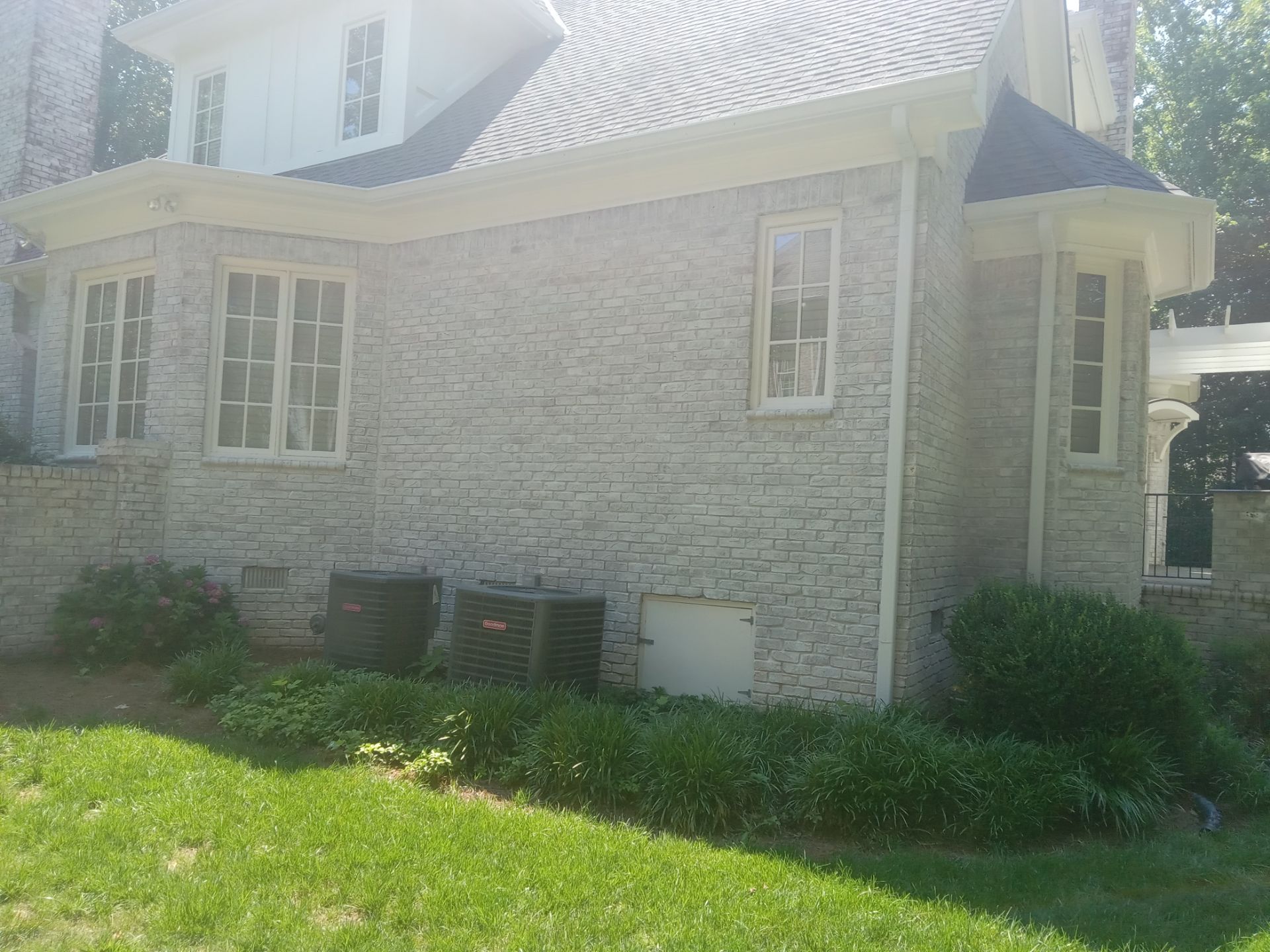 pressure washing brick exterior walls of a house removing dirt buildup and stains for clean and maintained appearance