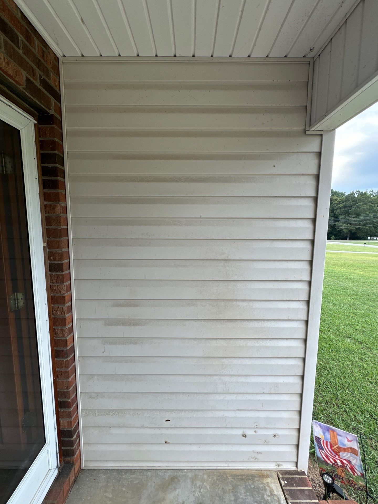 the service being performed is cleaning the vinyl siding to remove dirt and stains for a refreshed appearance