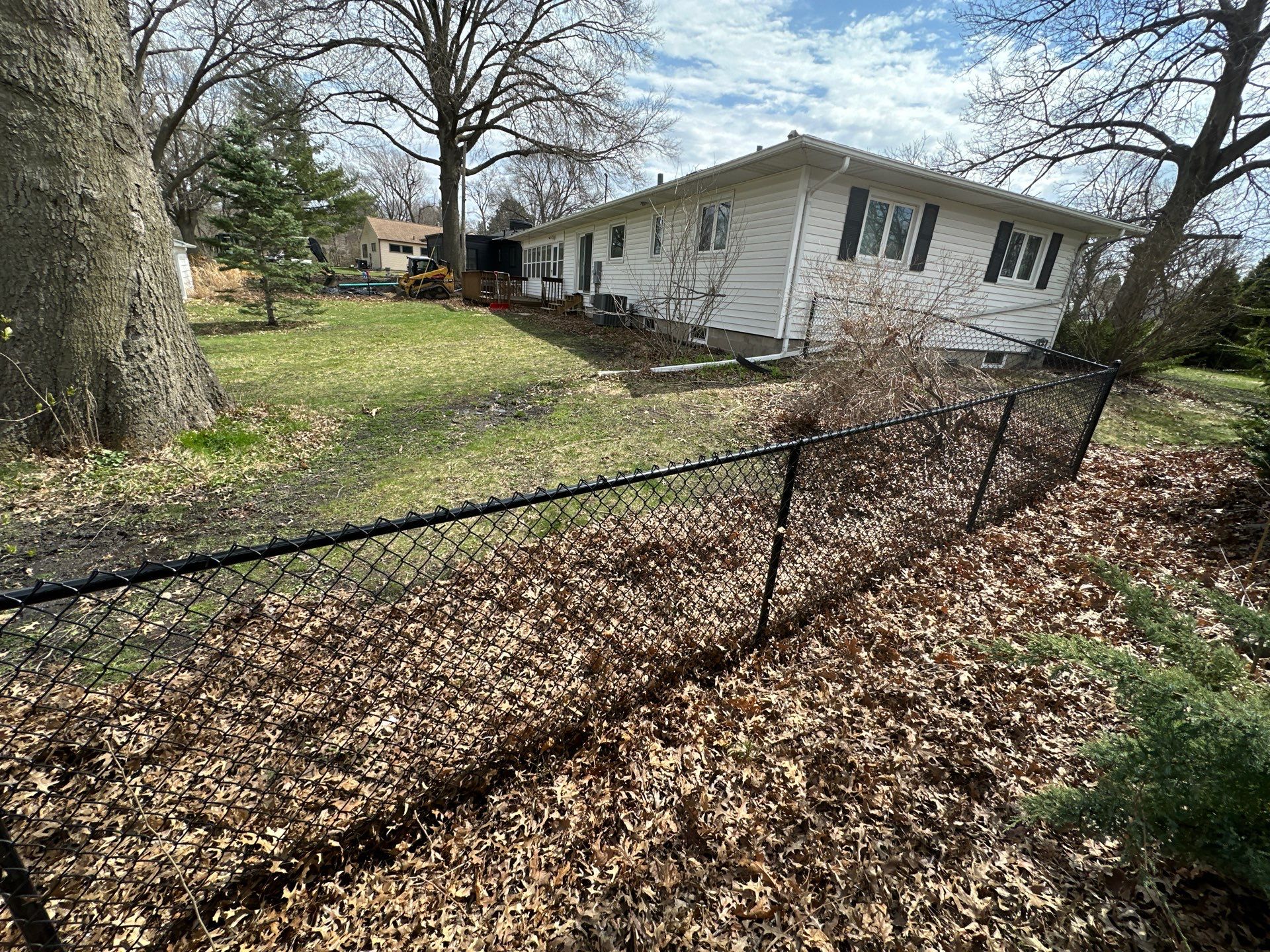 Black Vinyl-Coated Chain Link Fence Installation in Cedar Falls by Perfect Picket Fence and Stain