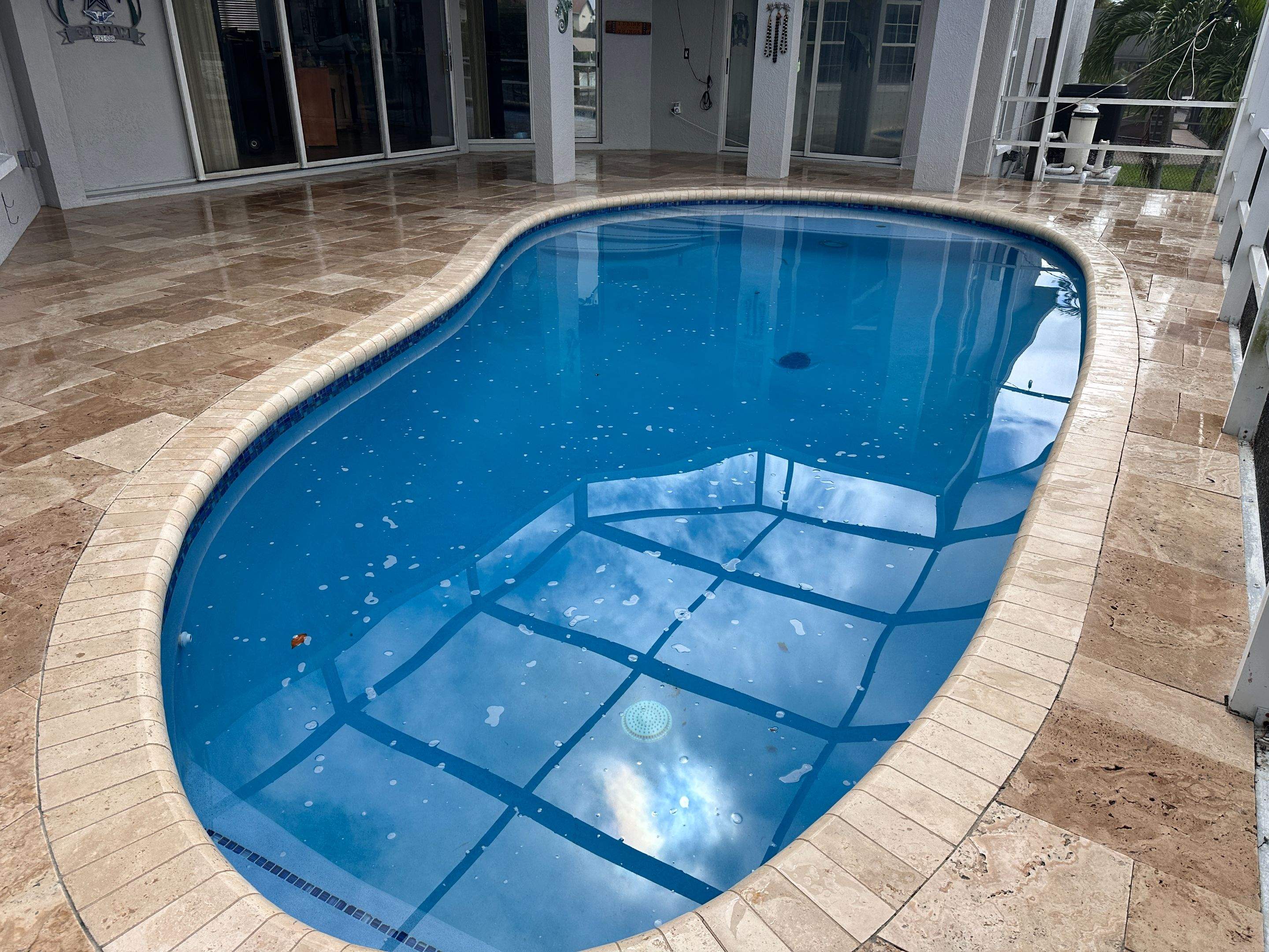 Travertine Sealing and Stripping for a Waterfront Pool Deck in Apollo Beach by Supreme Paver Experts