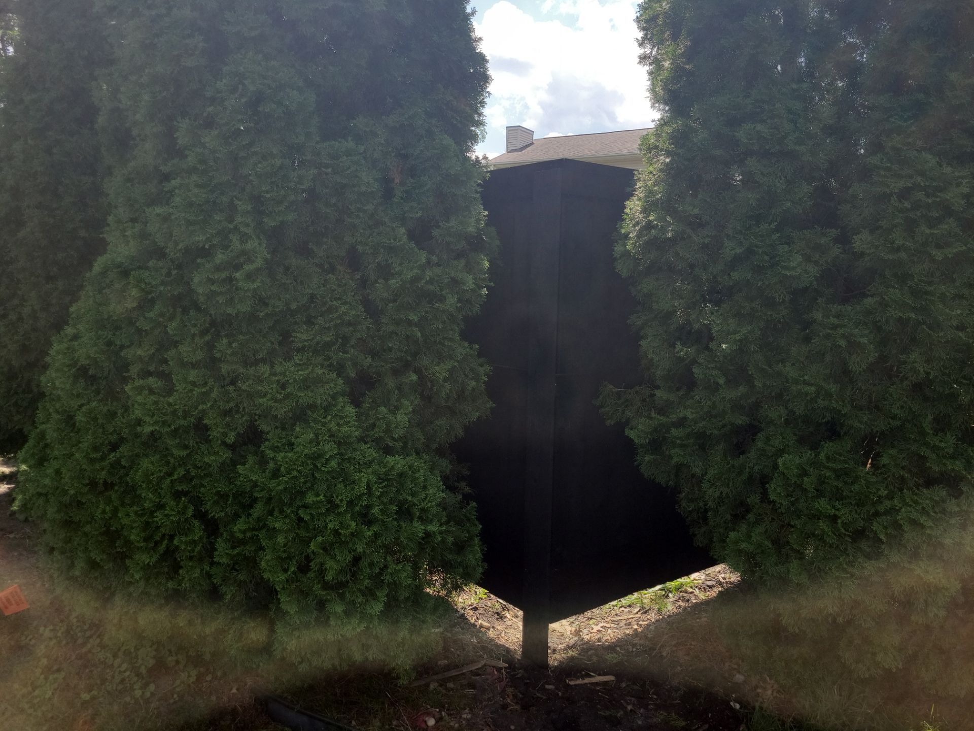 Black Wood Privacy Fence and Circular Stone Patio in Waverly by Perfect Picket Fence and Stain