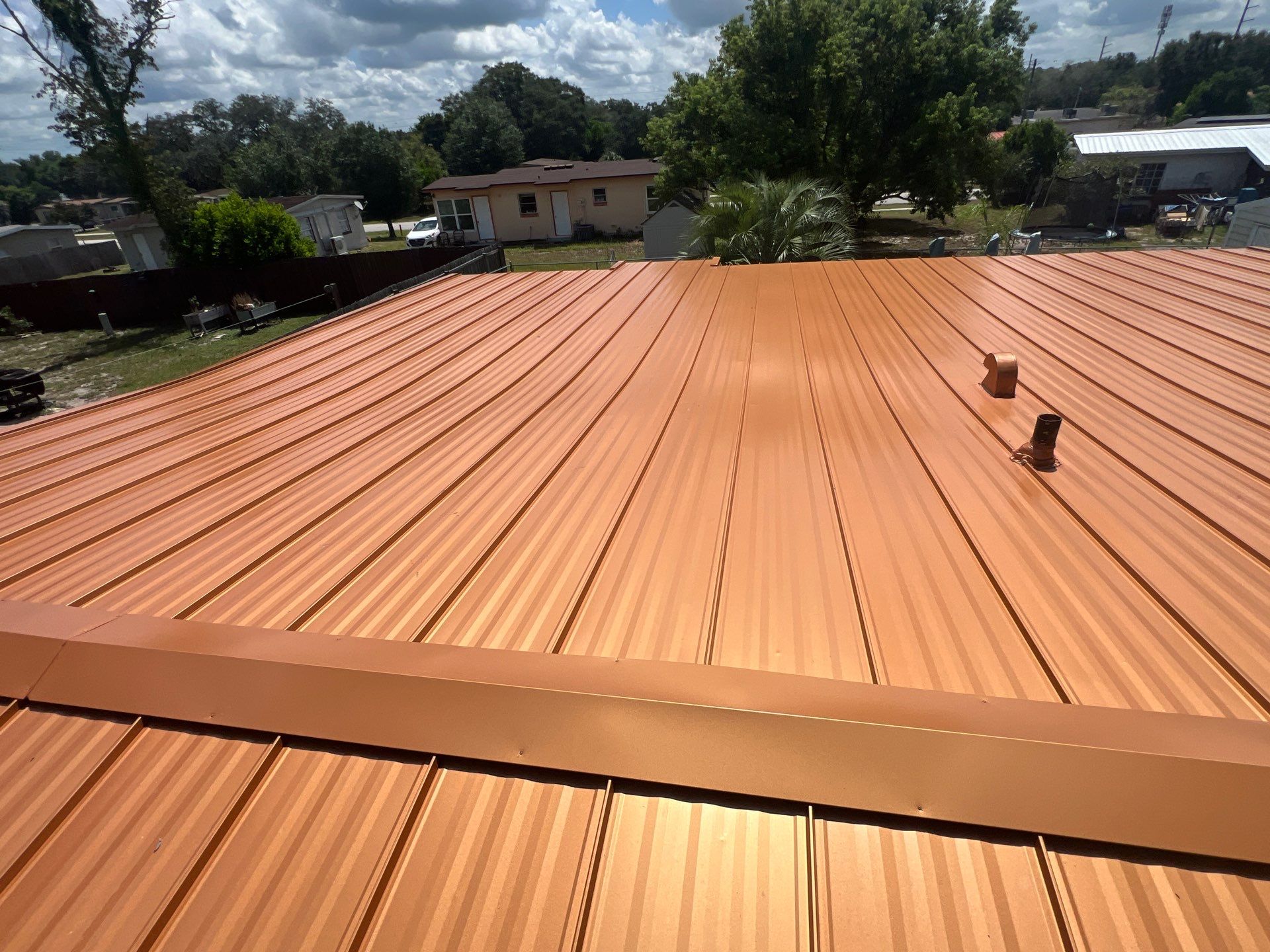 Standing Seam Metallic Copper Metal Roof Replacement in Deltona by Pinnacle Roofing Group