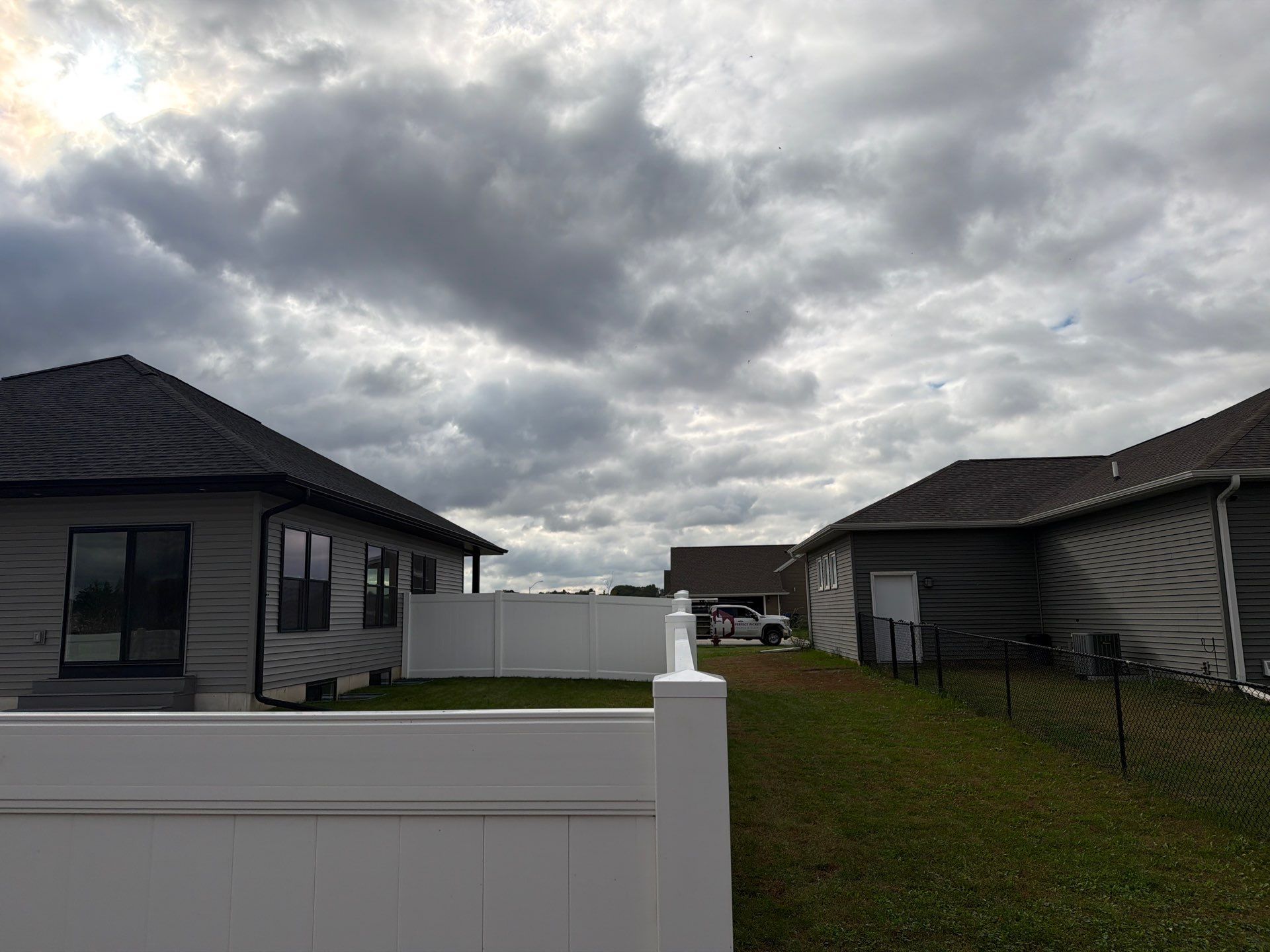 Residential White Vinyl Privacy Fence Installation in Janesville by Perfect Picket Fence and Stain