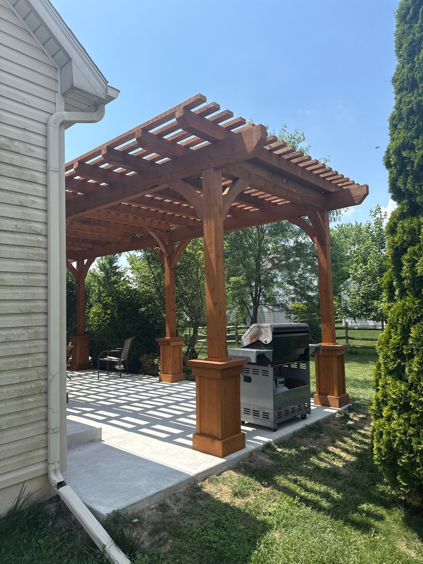 Custom Cedar Pergola and Concrete Patio Installation in Perrysburg by Farrell's Lawn & Garden Center LLC