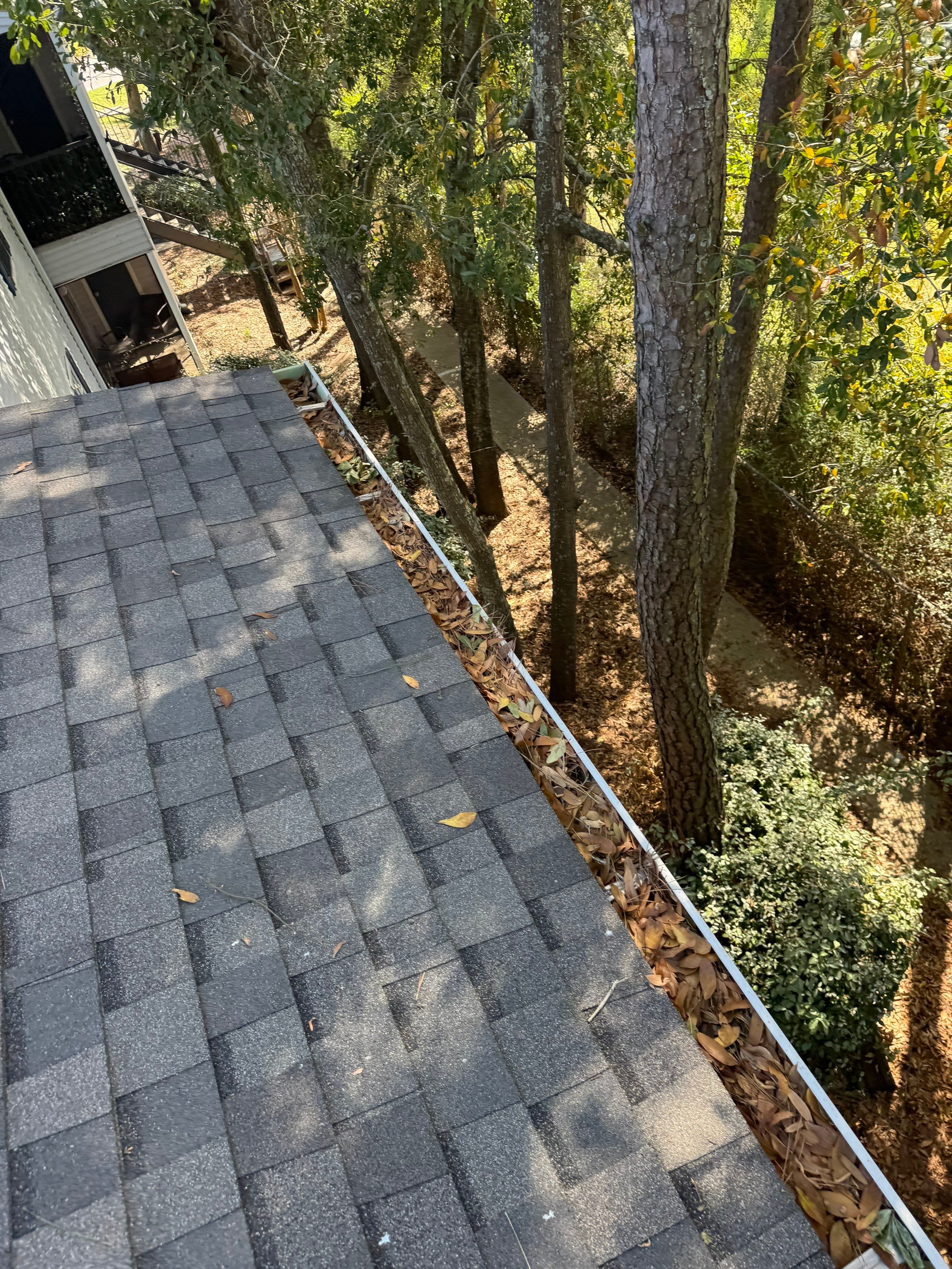 Commercial gutter cleaning Pensacola, FL before photo with filled gutters