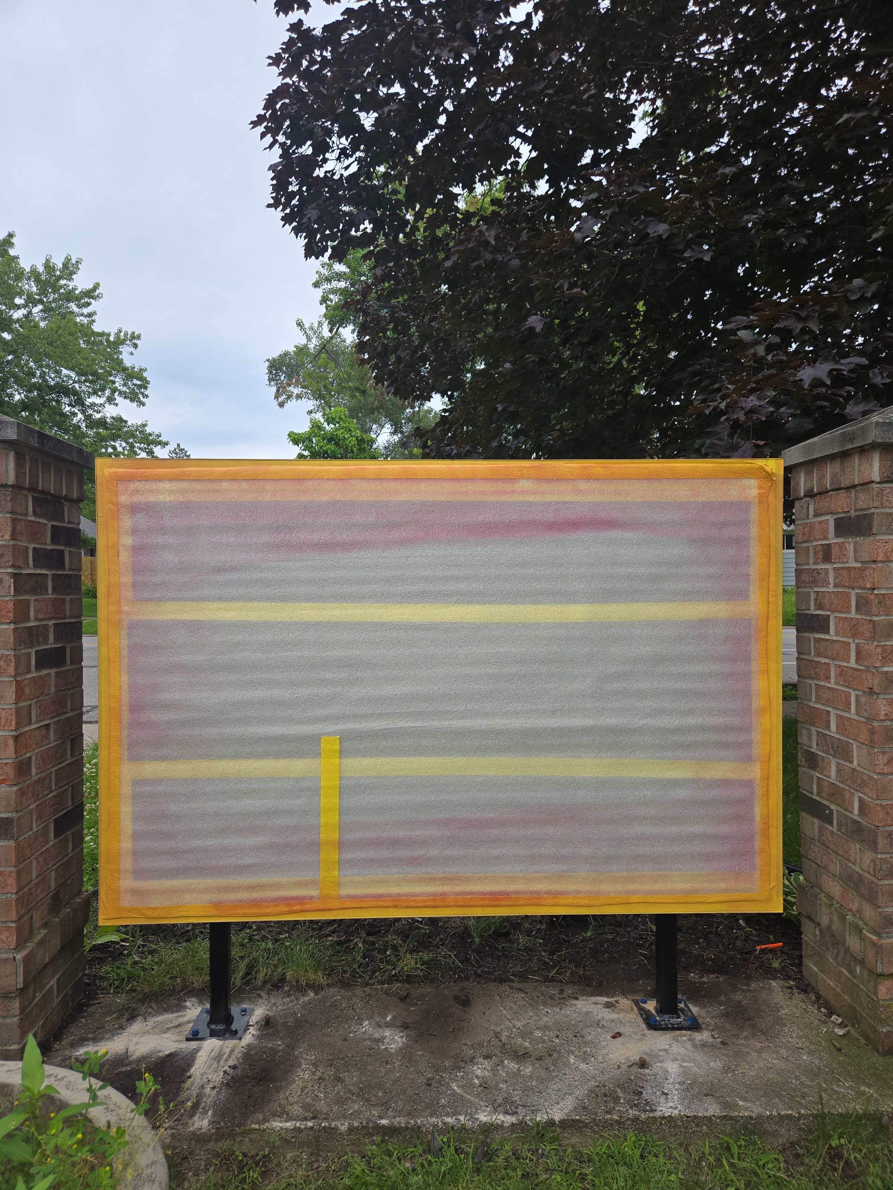 Monument Sign Installation Between Decorative Brick Pillars in South Bend by Hayes Design co