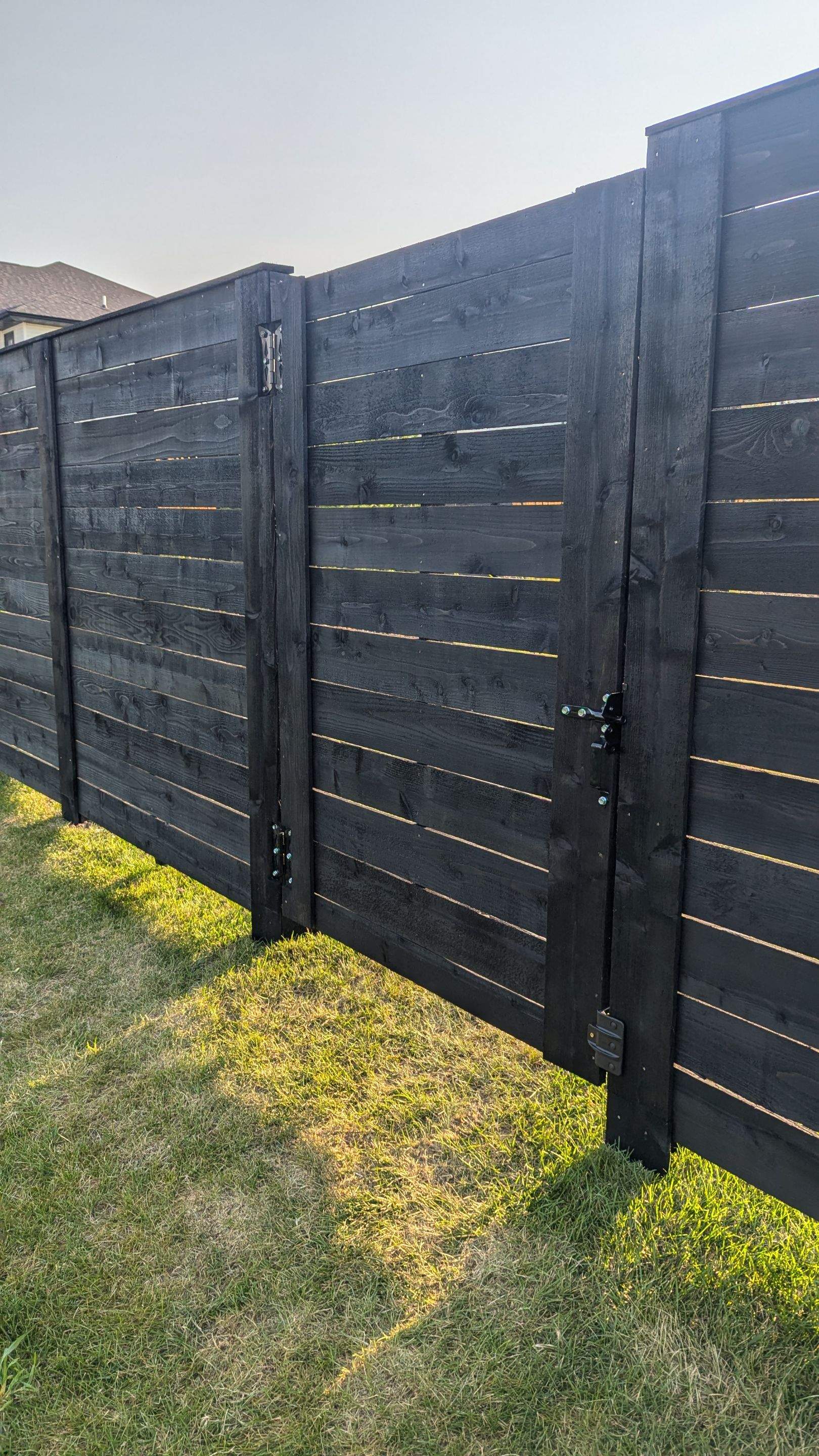 Modern Black Stained Horizontal Privacy Fence Installation in Cedar by Perfect Picket Fence and Stain