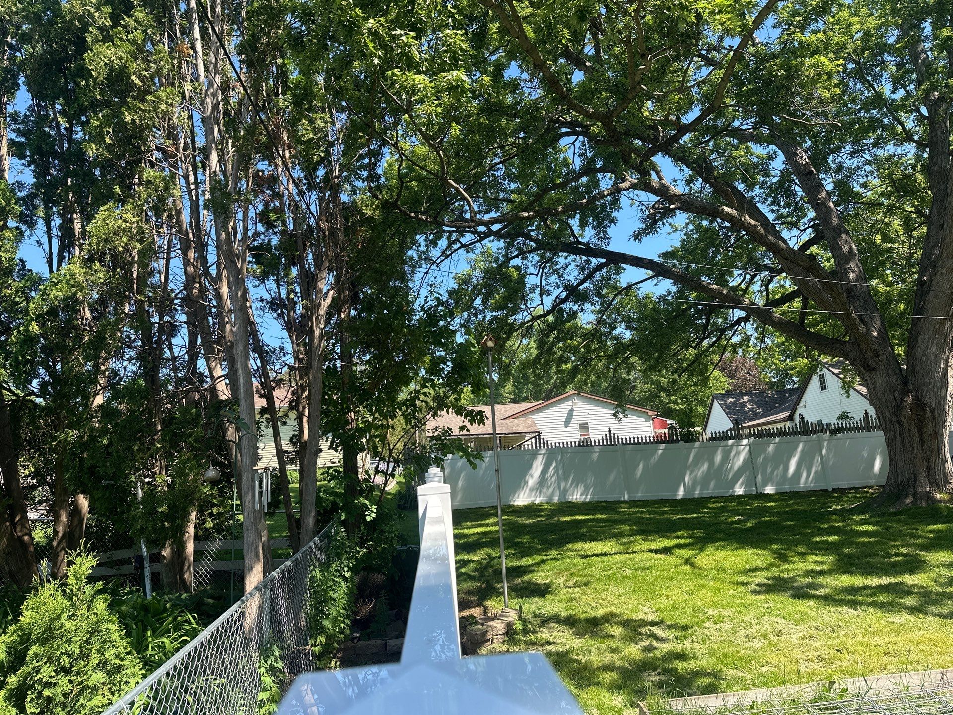 White Vinyl Privacy Fence and Double Gate Installation in Cedar Falls by Perfect Picket Fence and Stain