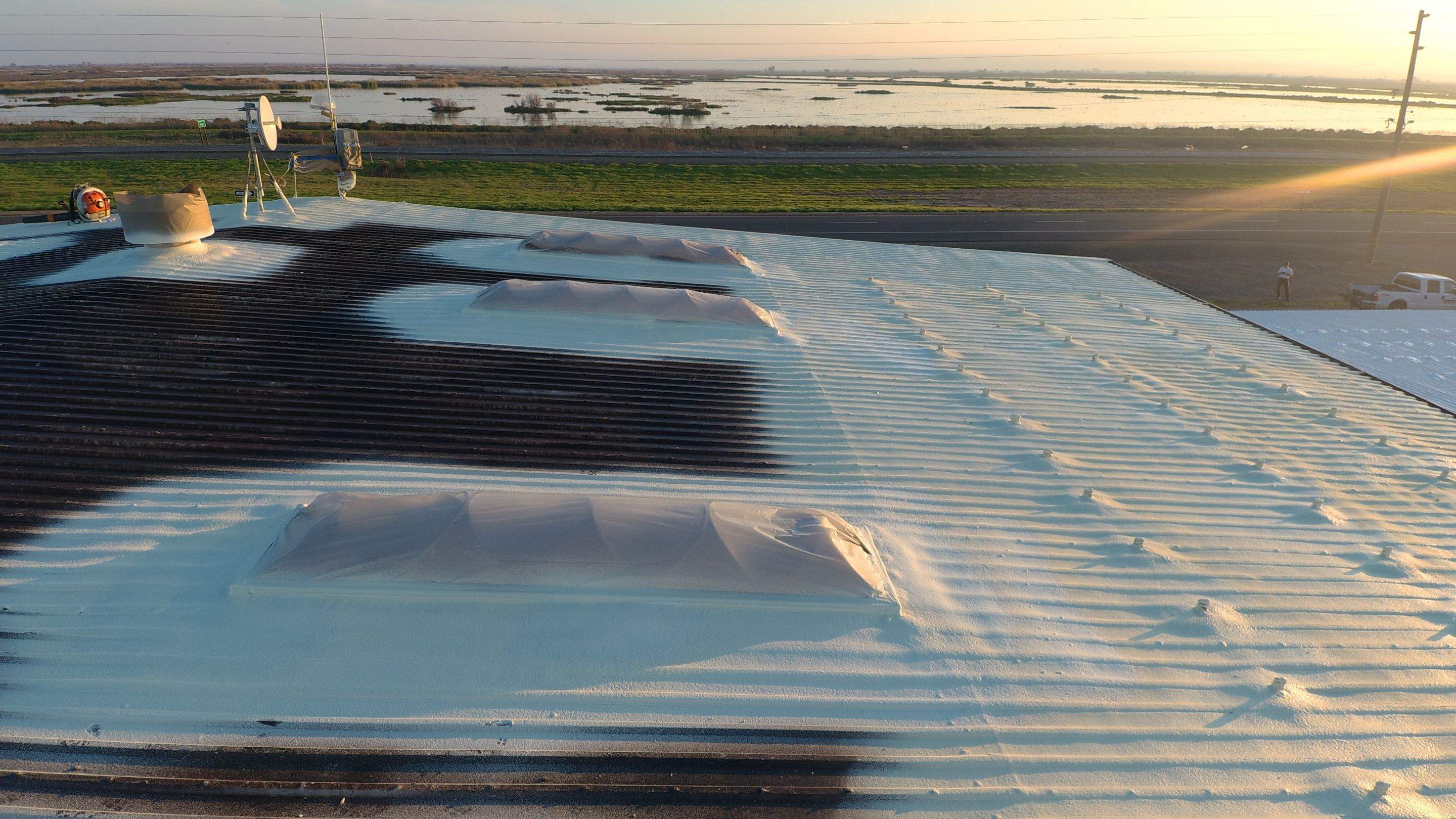 Metal roof restoration on commercial roof using Conklin Benchmark/ PUMA XL acrylic coatings over metal and foam by Straight Edge Roofing Inc