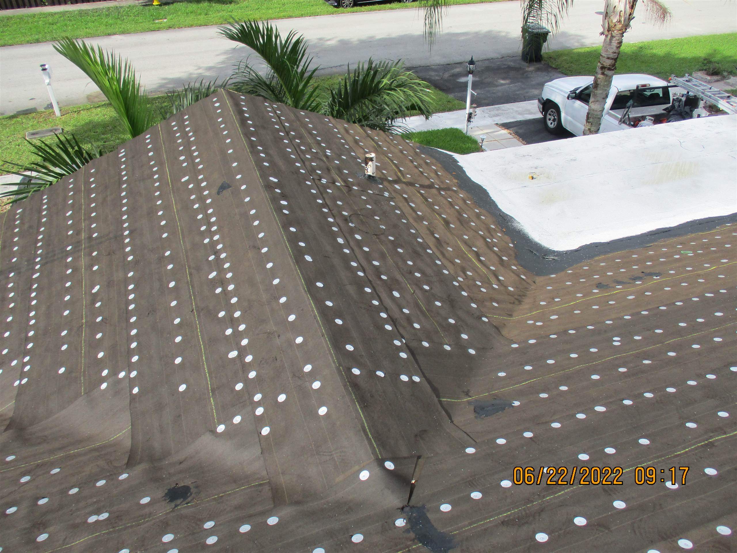 Residential Roofing Installation using 1.5" Nail Strip 24ga Solar White Kynar Coated Standing Seam Metal Panels by Morton Roofing, Inc.