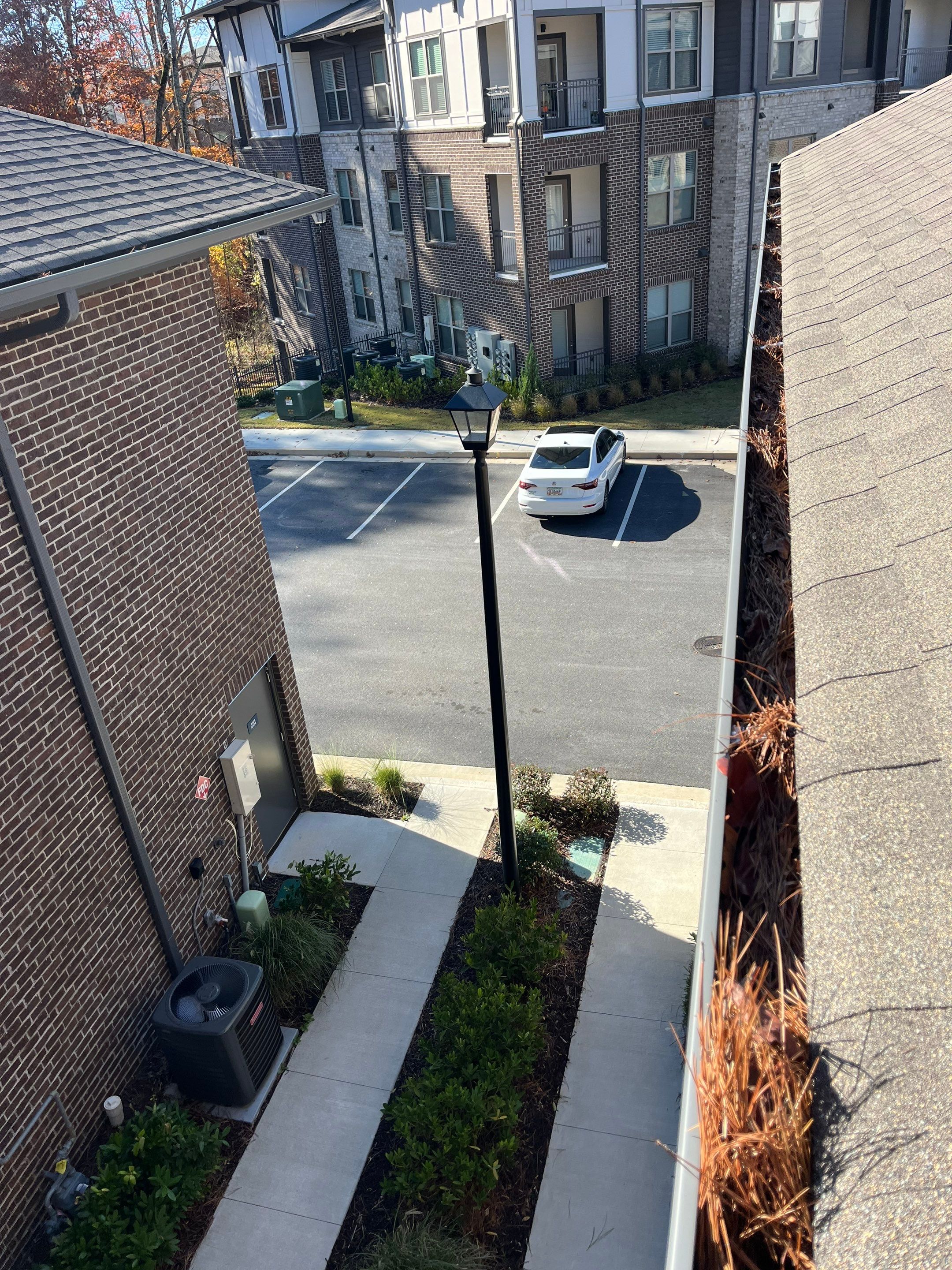 Commercial gutter cleaning Newnan & Peachtree City, GA before photo with filled gutters