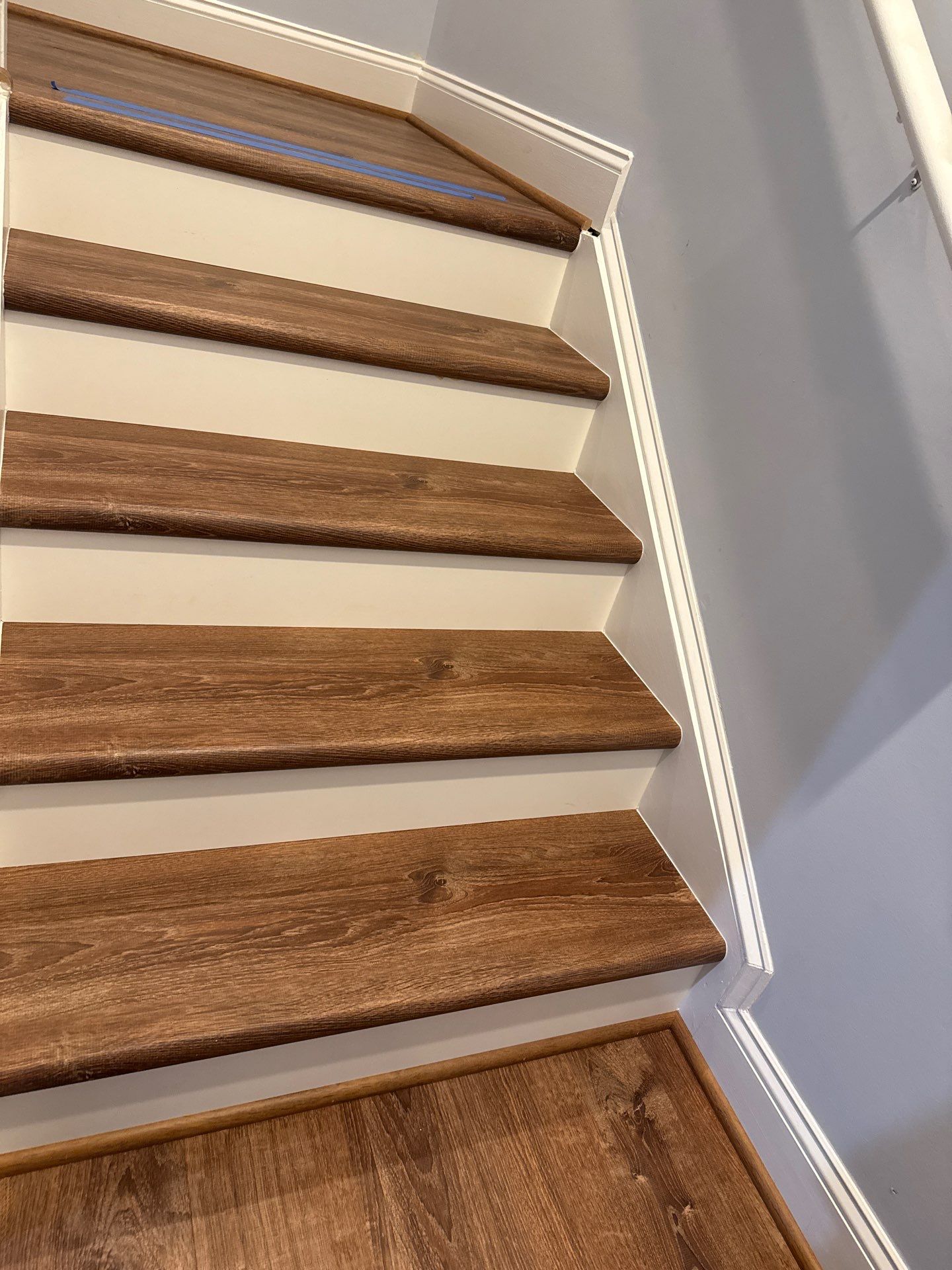 Stairway Installation using t vinyl stair tread and reversibleriser by La Bendicion Contruction Llc