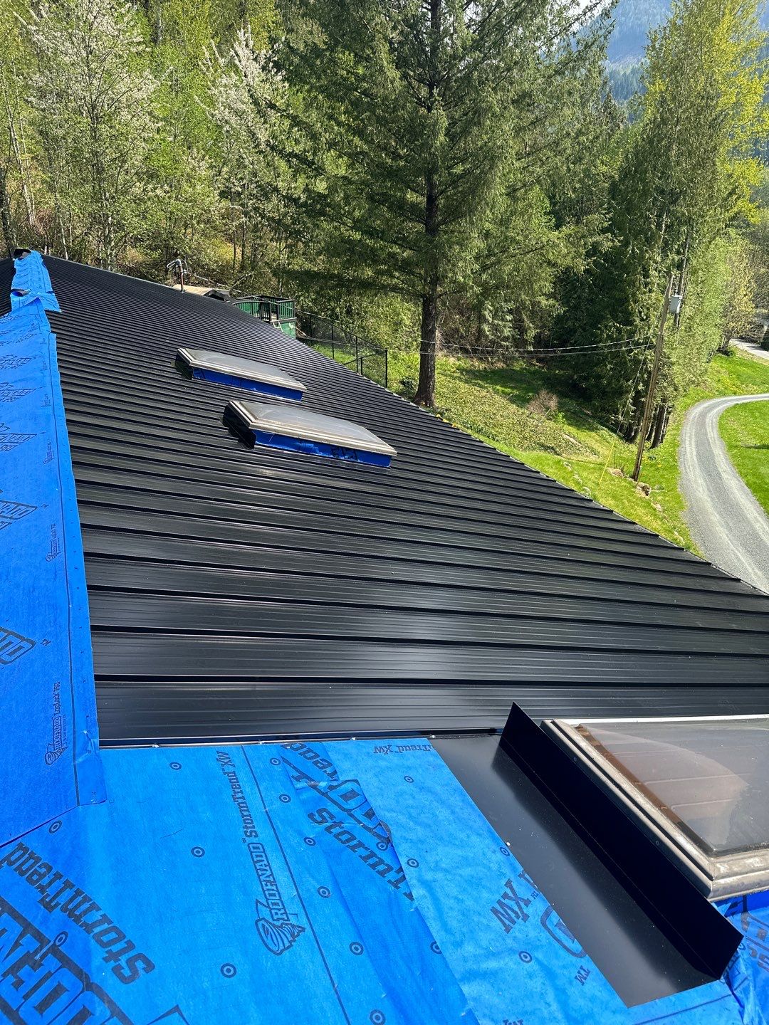 Residential ReRoofing Installation using 12" Prolok metal by Top Notch Roofing Inc
