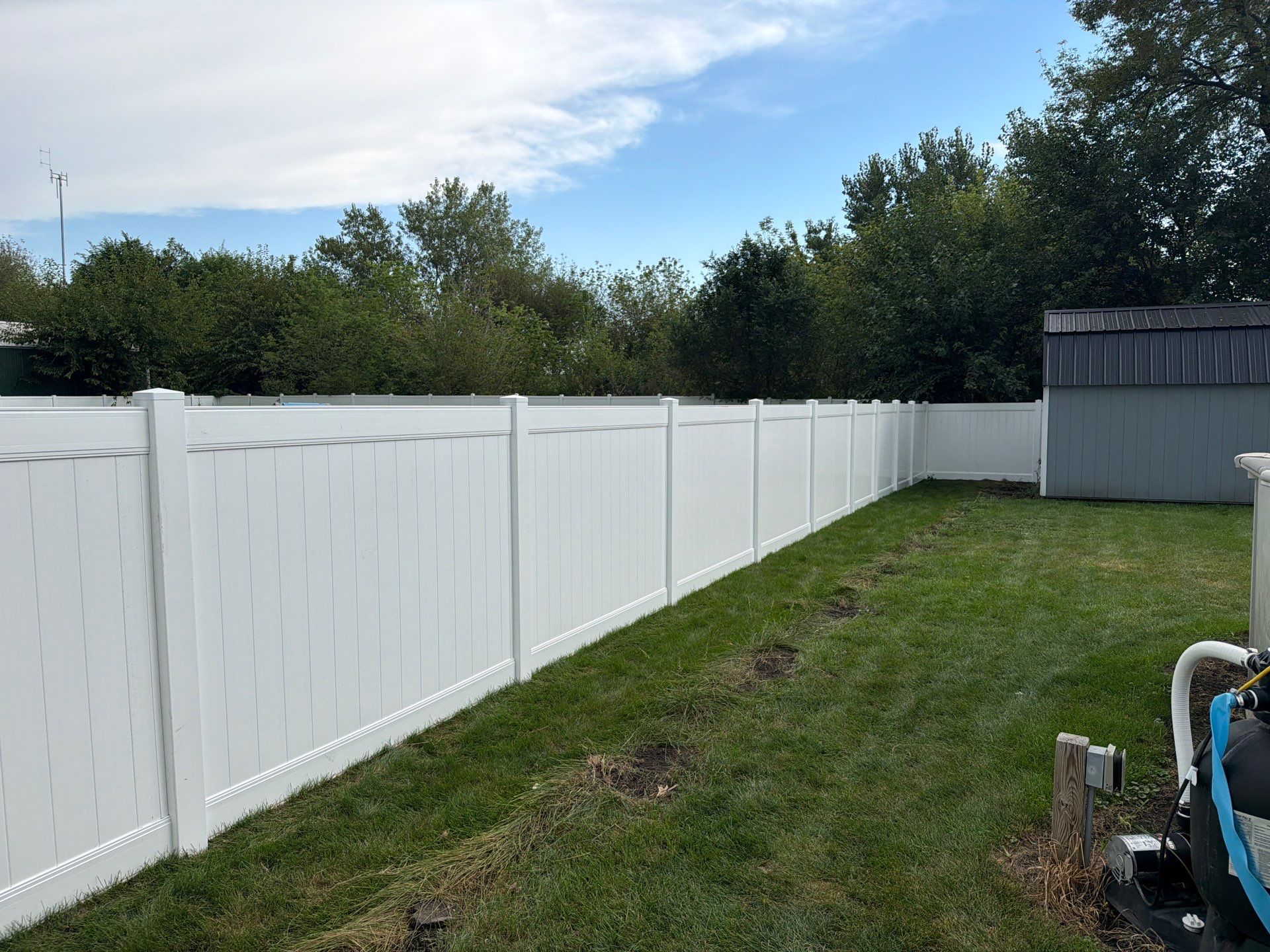 White Vinyl Privacy Fence Installation in Raymond, IA by Perfect Picket Fence and Stain