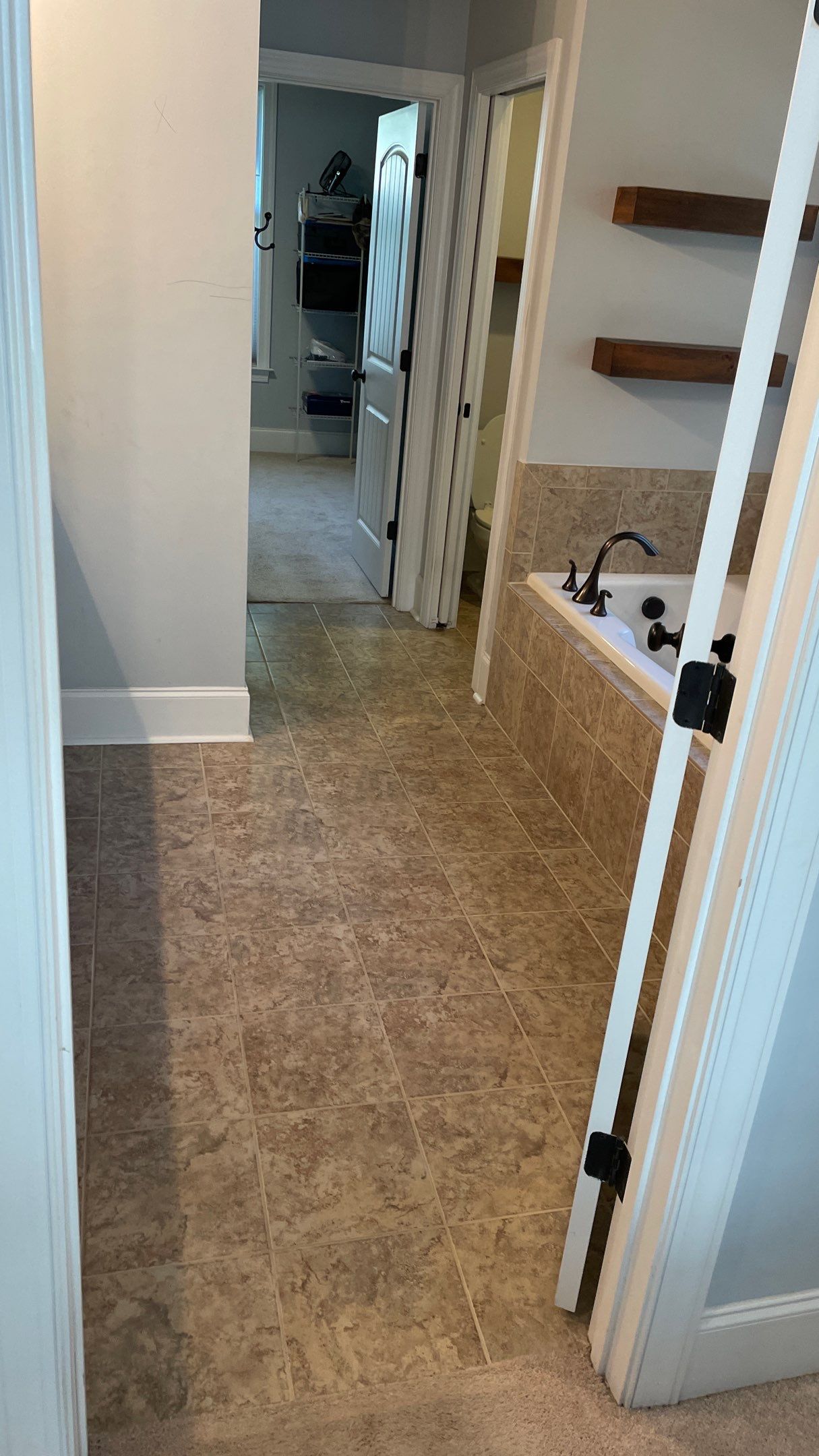 Bright Bathroom Remodel with Wall Removal, Stand Alone Tub and New Vanity by Footprints Floors of Coastal Carolina