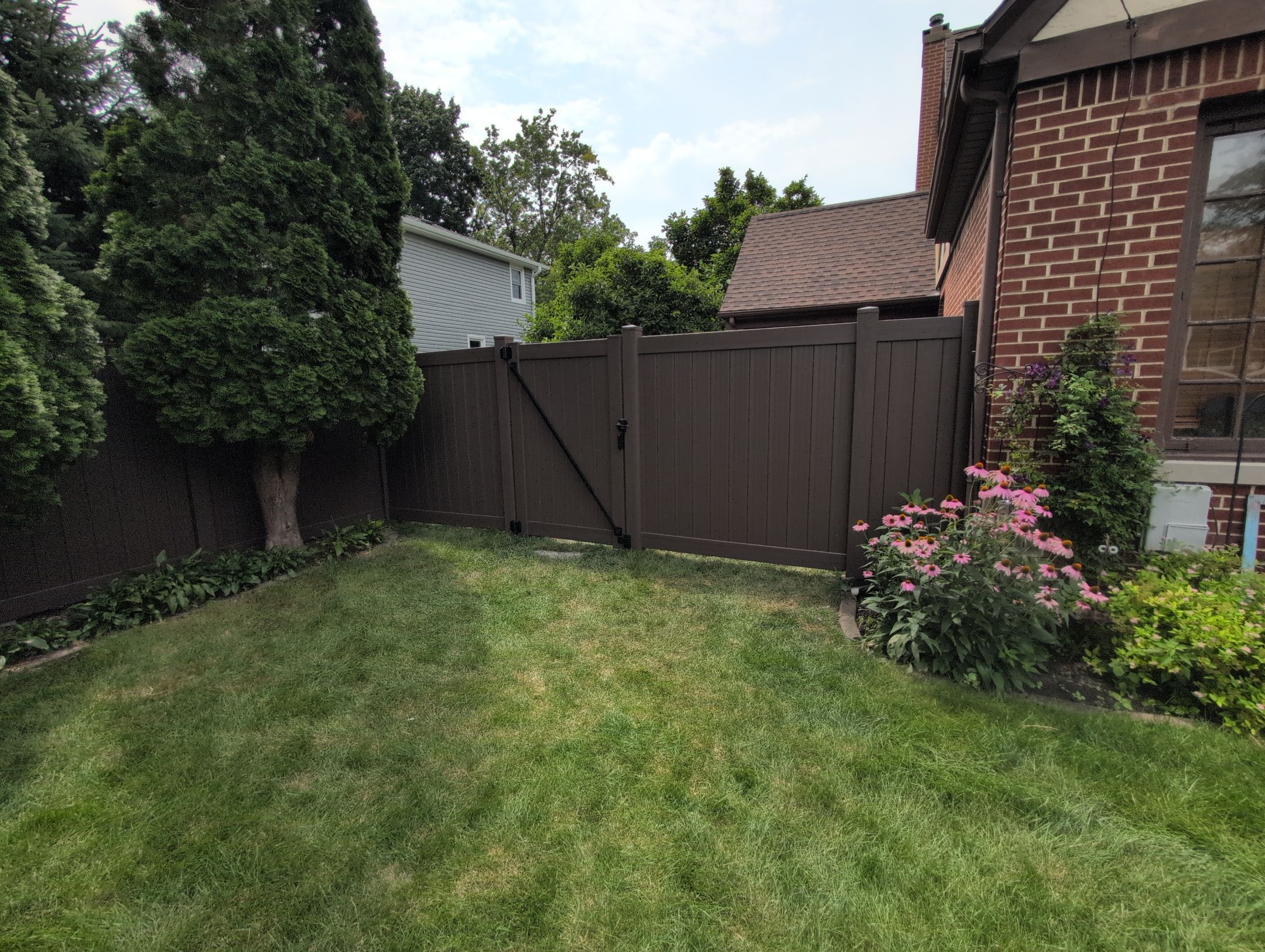 Walnut Vinyl Privacy Fence Installation in Waterloo by Perfect Picket Fence and Stain