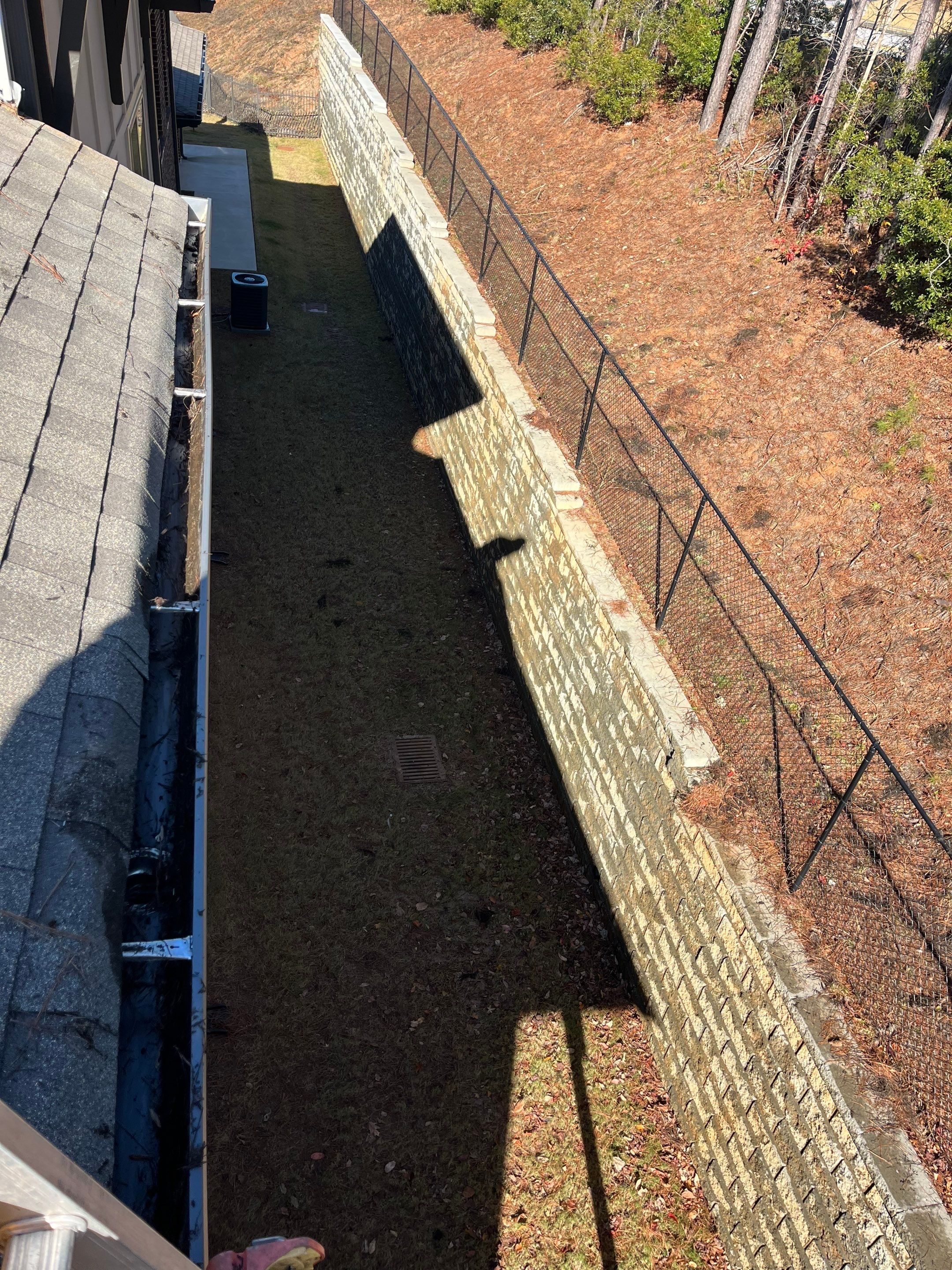 HOA gutter cleaning in Woodstock & Canton, GA, after  photo showing full gutters.